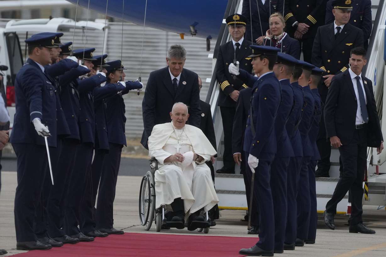 Pope Francis is welcomed by the honor guard as he arrives at the Figo Maduro airbase in Lisbon, Wednesday. Pope Francis arrived Wednesday in Lisbon to attend the international World Youth Day on Sunday that is expected to bring hundreds of thousands of young Catholic faithful to Portugal.