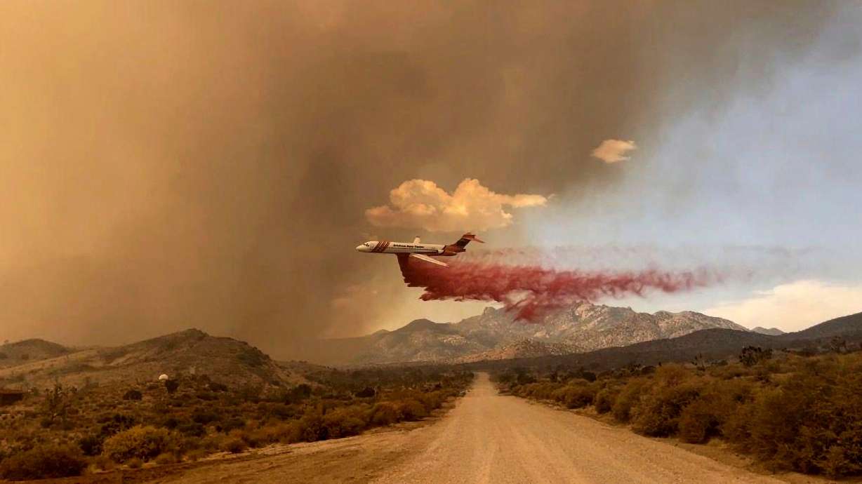 A tanker makes a fire retardant drop over the York Fire in Mojave National Preserve on Saturday.