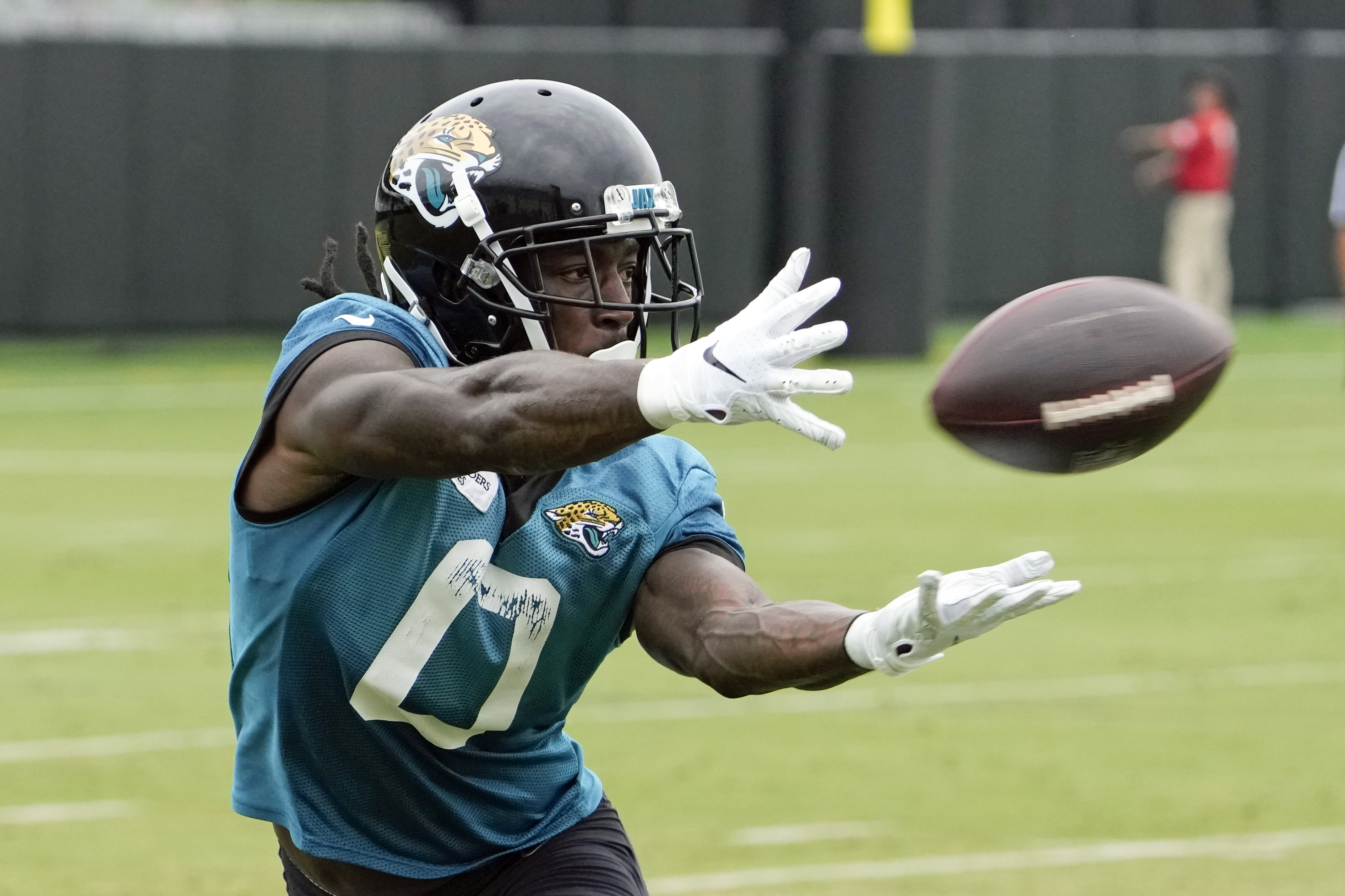 Jacksonville Jaguars wide receiver Calvin Ridley (0) makes a catch during a passing drill in practice at the NFL football team's training camp, Monday, July 31, 2023, in Jacksonville, Fla.