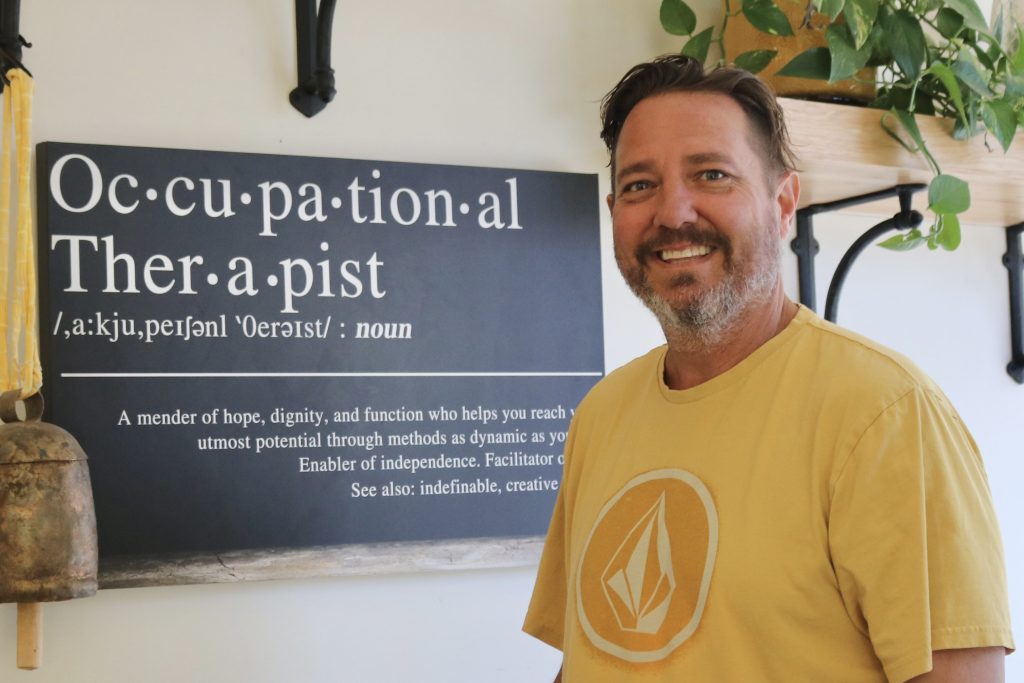 Matt Humphrey, who recently experienced a massive stroke, takes a photo inside his occupational therapy office in Hurricane, July 26.