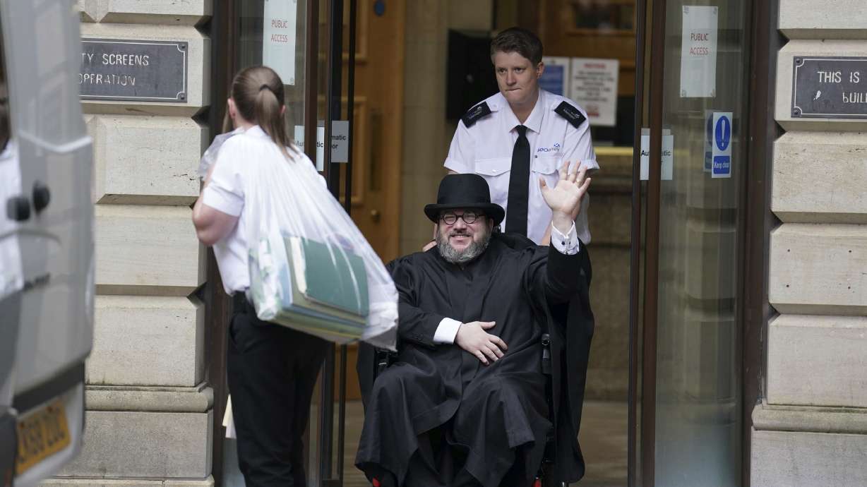 Nicholas Rossi waves as he leaves the Edinburgh Sheriff and Justice of the Peace Court in Edinburgh, Scotland, July 12. Rossi, a fugitive accused of faking his own death to avoid a rape charge in Utah, was ordered extradited Wednesday.