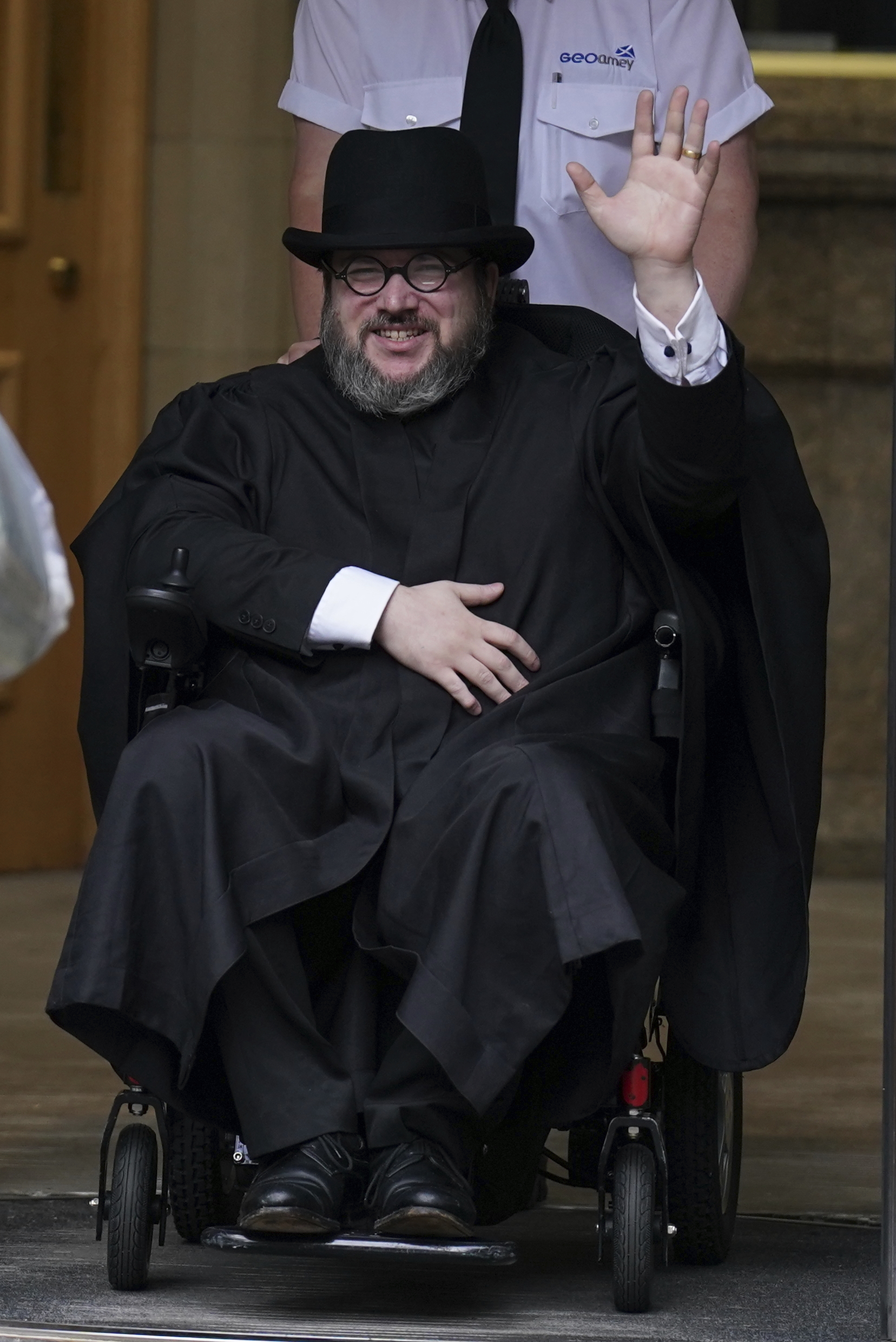 Nicholas Rossi waves as he leaves the Edinburgh Sheriff and Justice of the Peace Court in Edinburgh, Scotland, July 12, 2023. He was extradited to the U.S. and is now in the Davis County Jail awaiting trial on two separate rape charges.