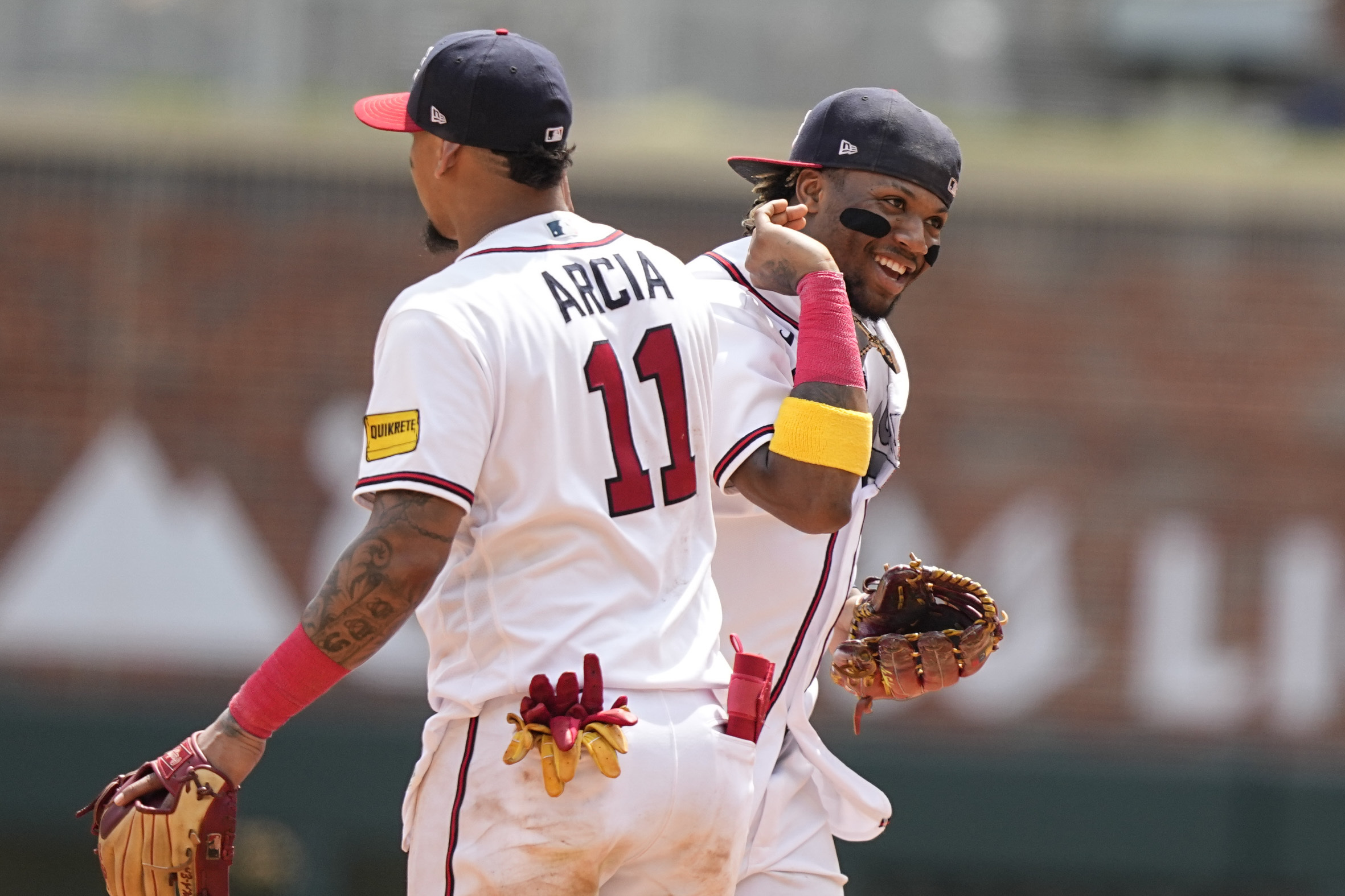 Atlanta Braves' Ronald Acuna Jr. celebrates a win against the Los Angeles Angels with teammate Orlando Arcia (11) after a baseball game, Wednesday, Aug. 2, 2023, in Atlanta. 