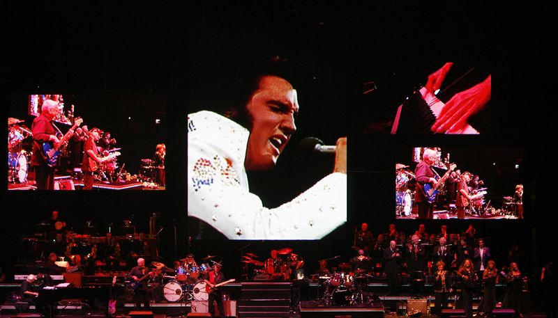 A live band backs up a virtual Elvis Presley during a memorial concert of Elvis footage in Memphis, Tennessee, Aug. 16, 2007.