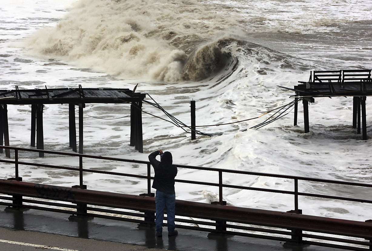 Powerful waves batter the Capitola Wharf after the storm destroyed a section of the structure on Jan. 5, in Capitola, Calif. Giant waves, measuring as high as 13 feet, are becoming more common off California's Pacific coast as the planet warms, according to new research that used a unique approach to gather historical data over the past 90 years to track the increasing height of the surf.