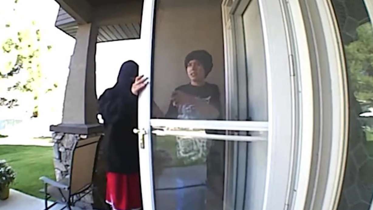 A 79-year-old woman was left bloodied and bruised after she was assaulted by two attackers who police are trying to find. Two individuals in this screenshot taken from doorbell camera video are suspects.