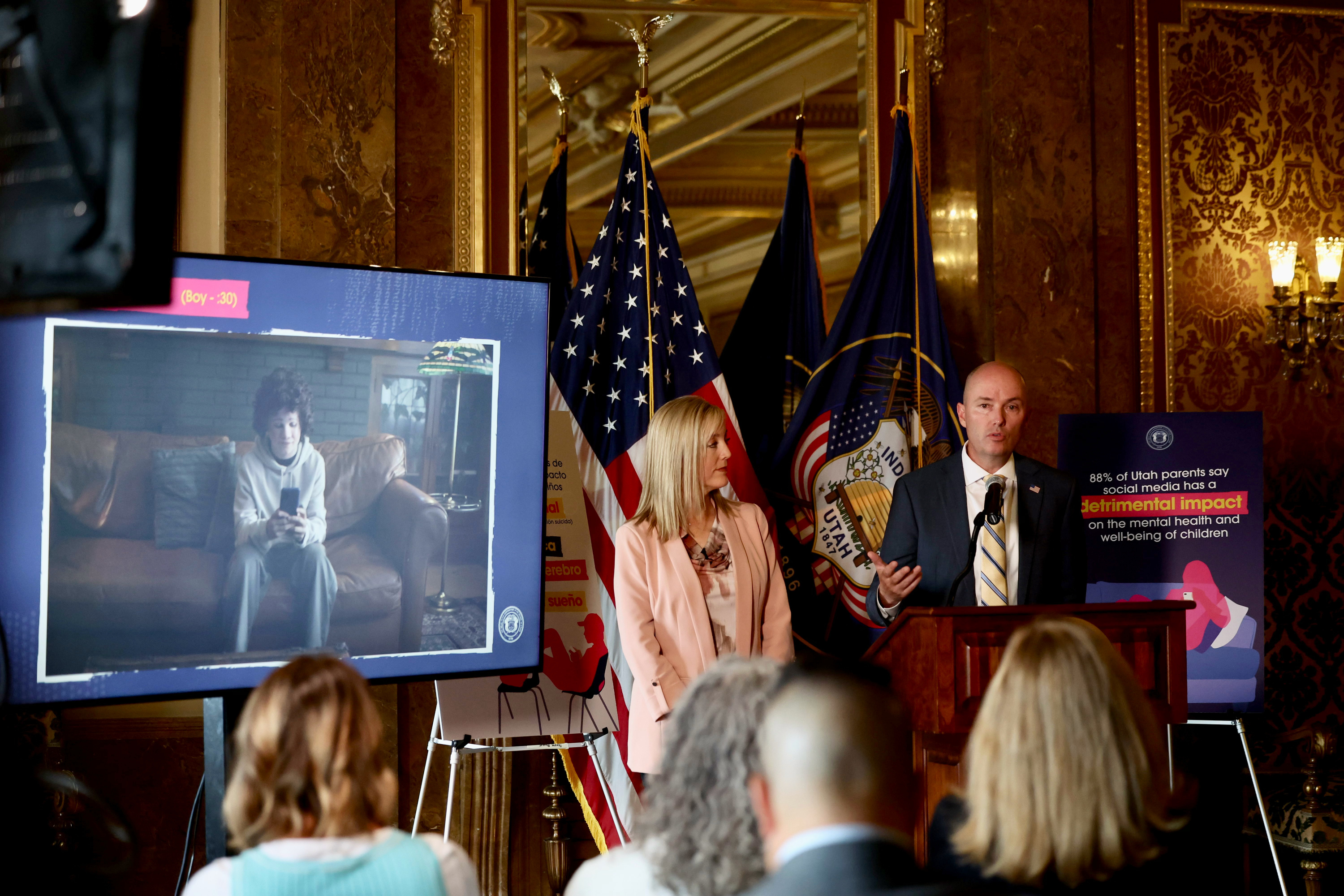 Aimee Winder Newton, director of the Office of Families, left, and Gov. Spencer Cox announce the launch of a public awareness campaign urging parents to learn about the harms social media has on youth at the state Capitol on Thursday.