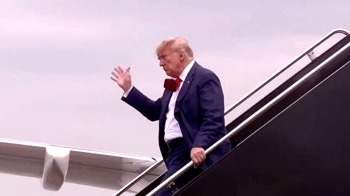 Former President Donald Trump, who pleaded not guilty in a federal court where he faced federal charges related to attempts to overturn his 2020 election defeat, waves as he arrives in this still image taken from video at Reagan Washington National Airport in nearby Arlington, Va., Thursday.