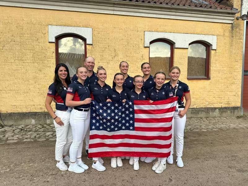 Utah-based Team USA's junior squad holds an American flag. The team placed third in the 2023 FEI World Championship for Young Vaulters on July 30.