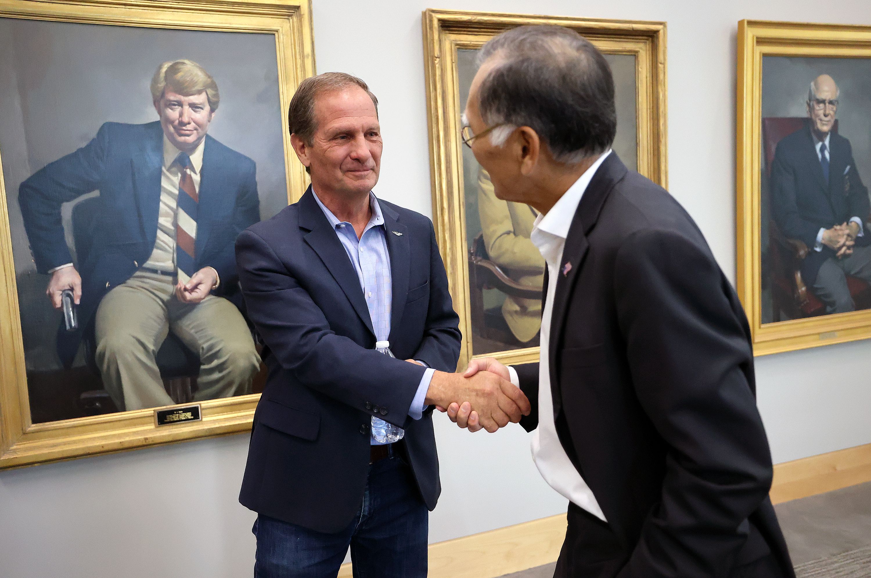 Rep. Chris Stewart, R-Utah, shakes hands with Brian Shiozawa, University of Utah Health associate vice president of health policy at the Hinckley Institute of Politics at the University of Utah in Salt Lake City on Thursday.