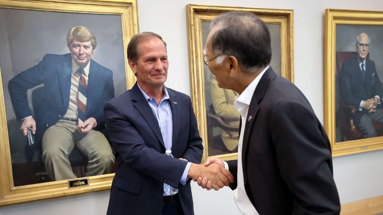 Rep. Chris Stewart, R-Utah, shakes hands with Brian Shiozawa, University of Utah Health associate vice president of health policy at the Hinckley Institute of Politics at the University of Utah in Salt Lake City on Thursday.