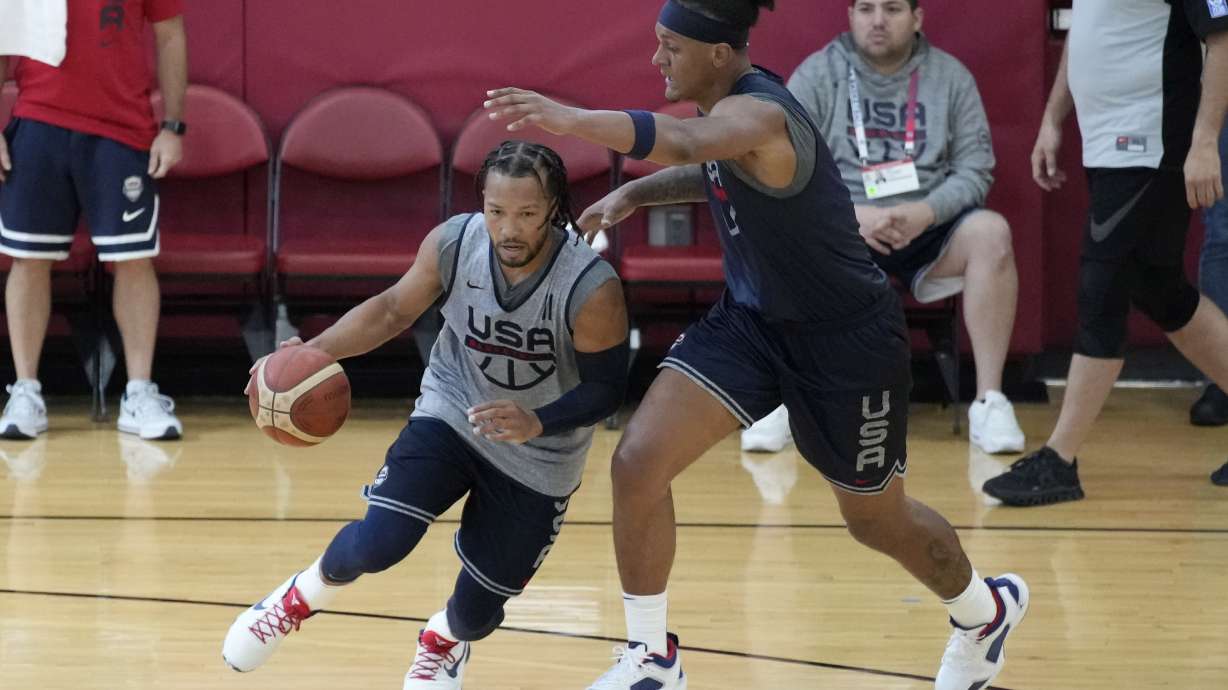 Jalen Brunson of the New York Knicks, left, drives against Paolo Banchero of the Orlando Magic during training camp for the United States men's basketball team Thursday, Aug. 3, 2023, in Las Vegas.