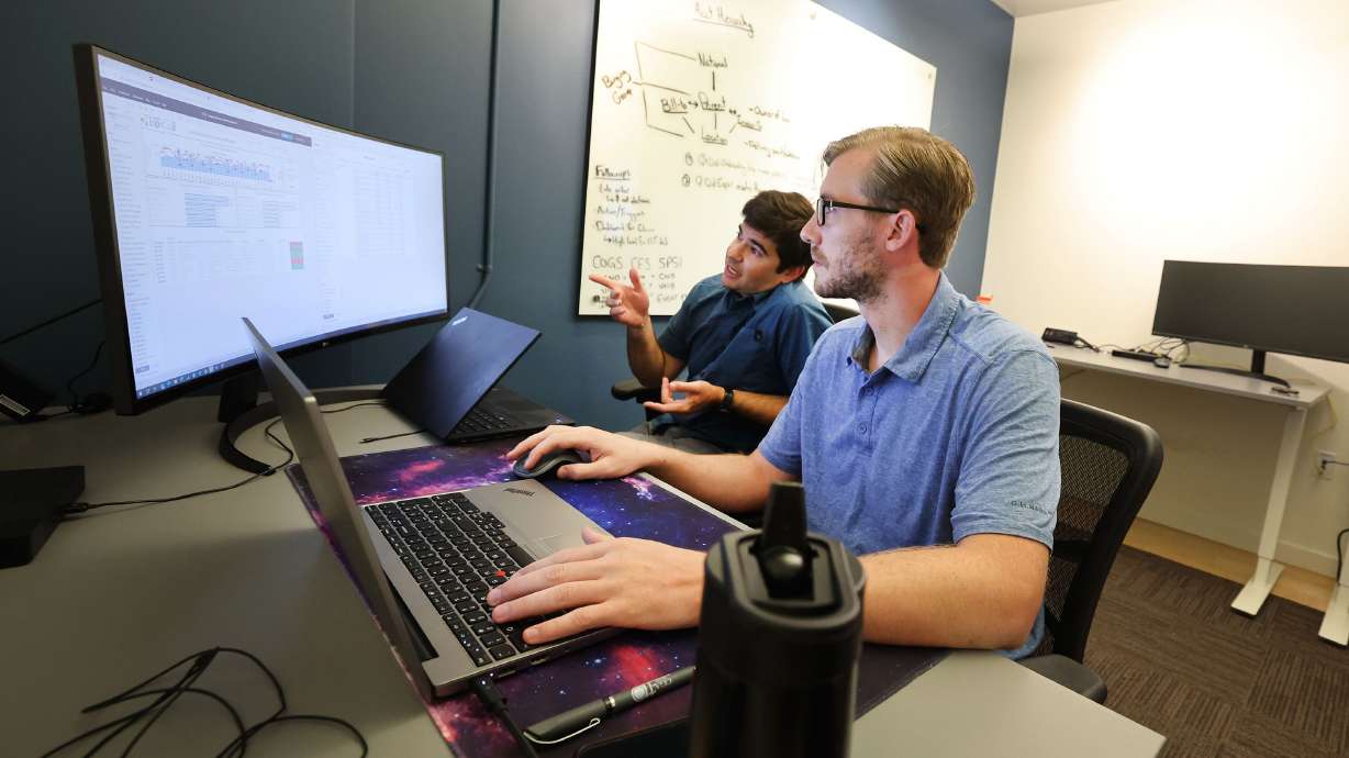Connor Perkett and Hunter Harmer of EspriGas work in their office at Work Hive in Salt Lake City on Tuesday. Summertime vacations can make it challenging to maintain workplace productivity with fewer people in the office, but experts say less vacation time isn't a good way to solve the problem.