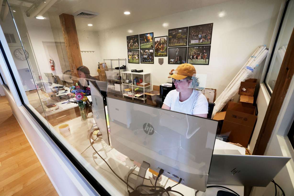 Emma Black and Megan Ware of Major League Rugby join an online work call while at work in space at Work Hive in Salt Lake City on Tuesday.