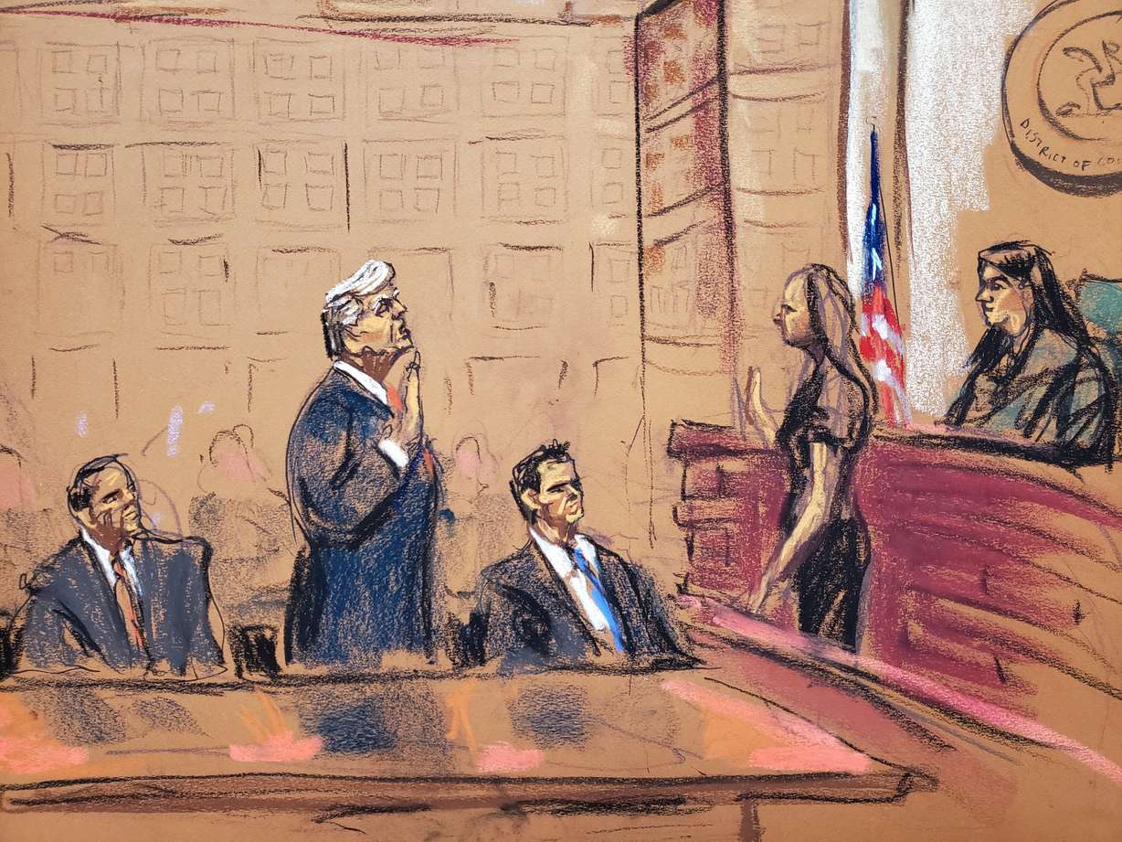 Former U.S. President Donald Trump stands between his attorneys Todd Blanche and John Lauro as he takes an oath before Magistrate Judge Moxila A. Upadhyaya during his plea hearing on charges that he orchestrated a plot to try to overturn his 2020 election loss, at federal court in Washington, Thursday in a courtroom sketch.