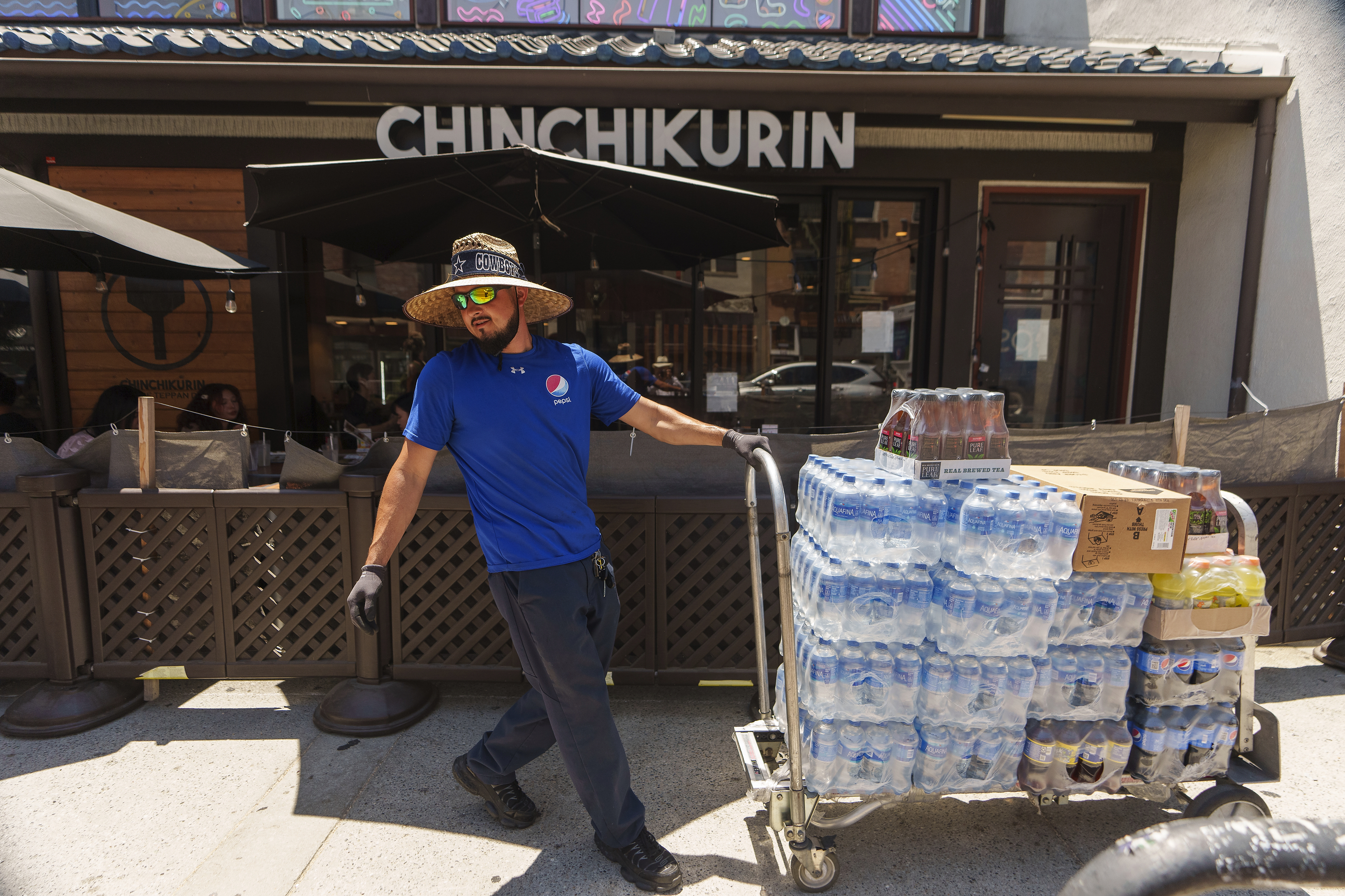 Driver Jose Viveros delivers beverages in the Little Tokyo district of Los Angeles, July 27. The U.S. unemployment rate dipped to 3.5% last month in a sign that the job market remains resilient, the government reported Friday. 