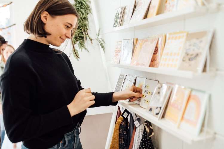 A woman looks through different products at The Land of Salt. The business had particularly struggled during the construction, especially as it halted consumer traffic and limited parking.