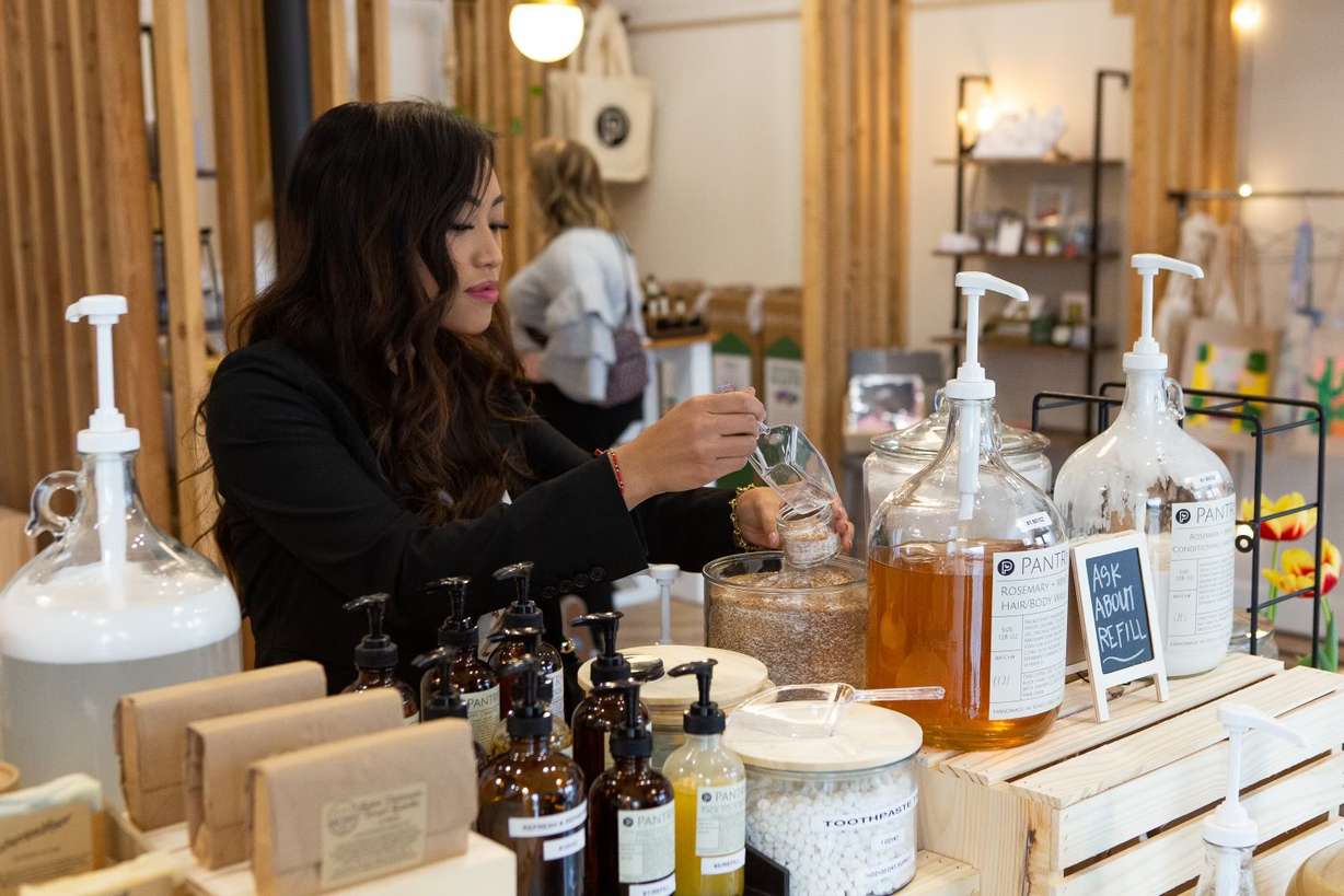 A woman tests products at Pantry Products: A Modern Apothecary, one of the women-owned businesses in the Maven District.