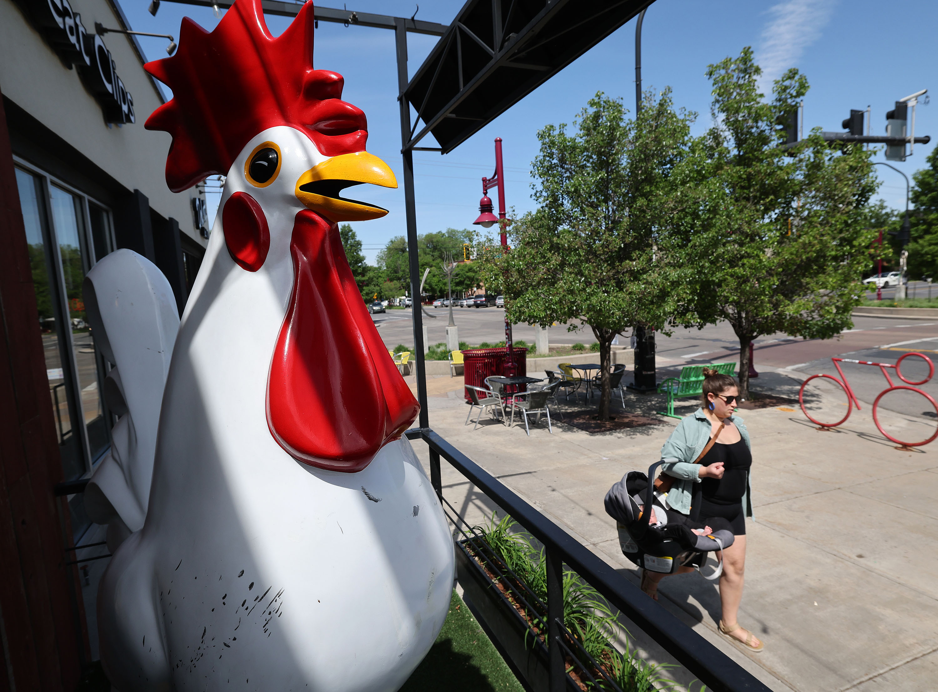 A woman walks with her child past the Crack Shack in the 9th and 9th area of Salt Lake City on May 31. The 9th and 9th intersection is scheduled to close as early as Monday and remained closed for about a month as a part of the ongoing 900 South Reconstruction Project.