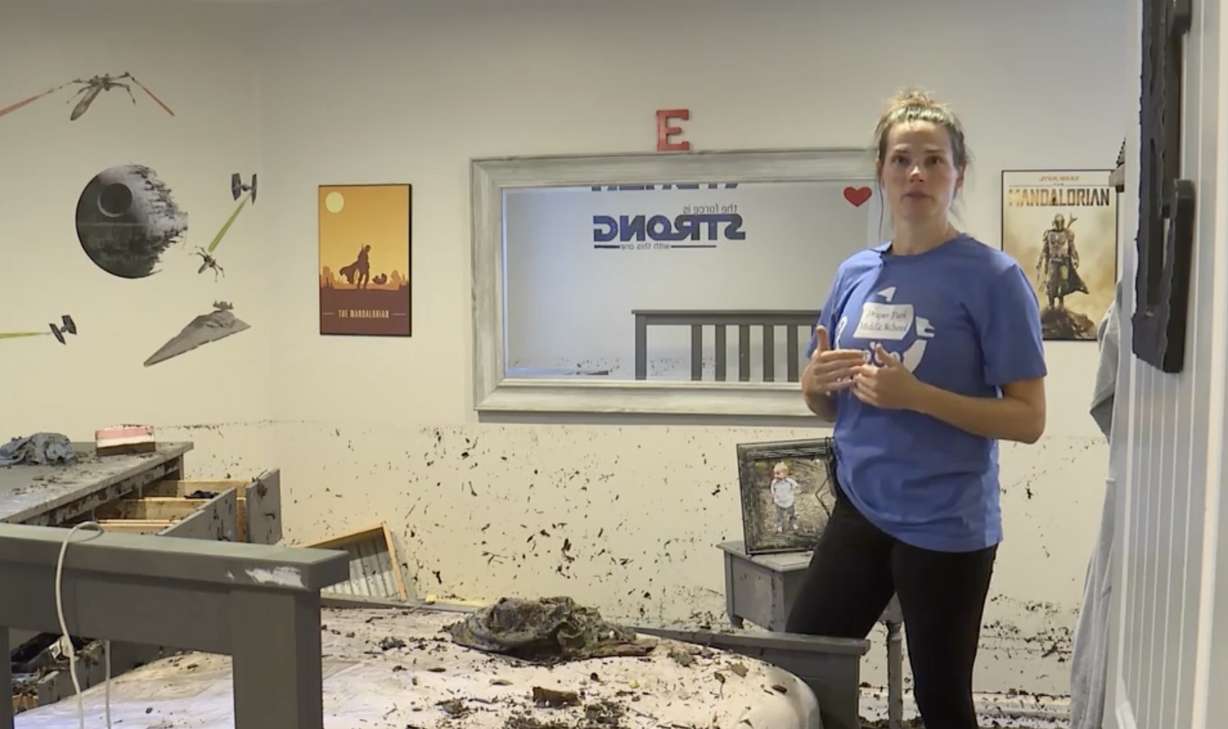 Erin Longacre shows KSL-TV the damage flood water did to her basement. She and other draper residents were recovering Friday from an intense rainstorm that left the city flooded with multiple street closures, a sinkhole and mudslides.