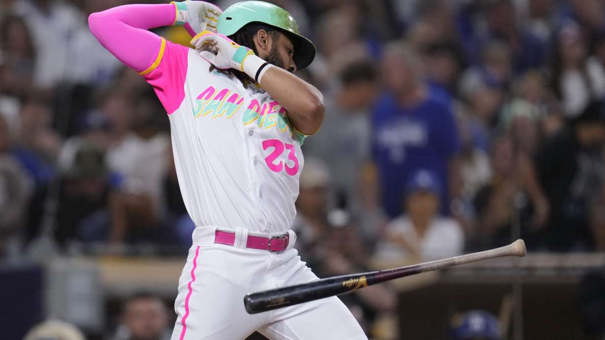 San Diego Padres' Fernando Tatis Jr. moves away from an inside pitch while batting during the fifth inning of a baseball game against the Los Angeles Dodgers, Friday, Aug. 4, 2023, in San Diego.
