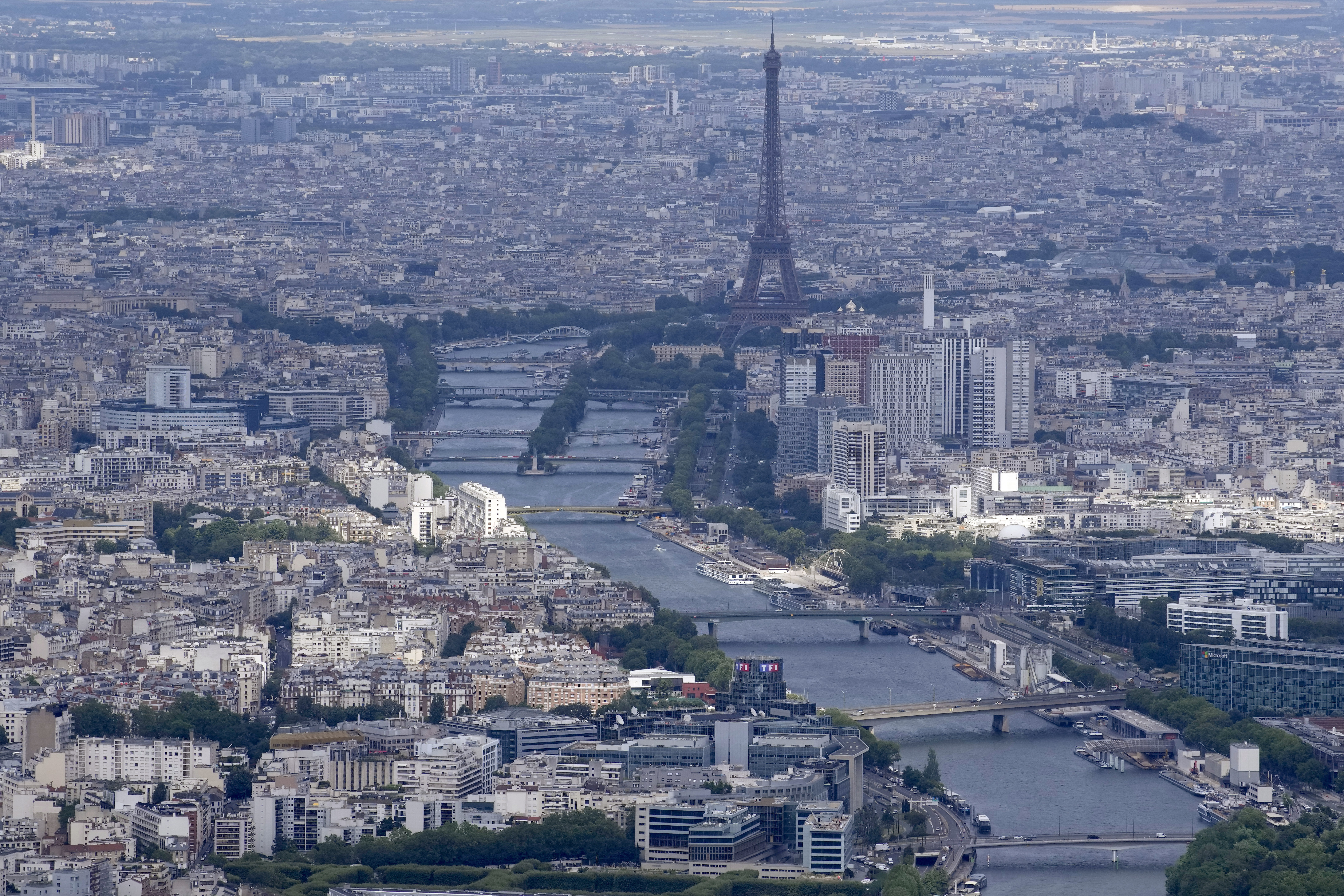 The Seine rivers flows though Paris, with the Eiffel Tower at center, in Paris, Tuesday, July 11, 2023. Heavy rains in Paris have dealt a blow to plans intended to test the French capital's readiness for swimmers to race in the River Seine at next year's Summer Olympics. A planned training session Friday Aug.4, 2023 for swimmers aiming to compete this weekend in the river that cuts through Paris was cancelled because the water quality dropped below acceptable standards.