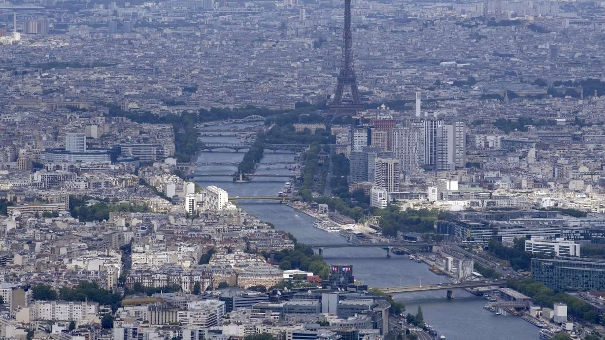 The Seine rivers flows though Paris, with the Eiffel Tower at center, in Paris, Tuesday, July 11, 2023. Heavy rains in Paris have dealt a blow to plans intended to test the French capital's readiness for swimmers to race in the River Seine at next year's Summer Olympics. A planned training session Friday Aug.4, 2023 for swimmers aiming to compete this weekend in the river that cuts through Paris was cancelled because the water quality dropped below acceptable standards.