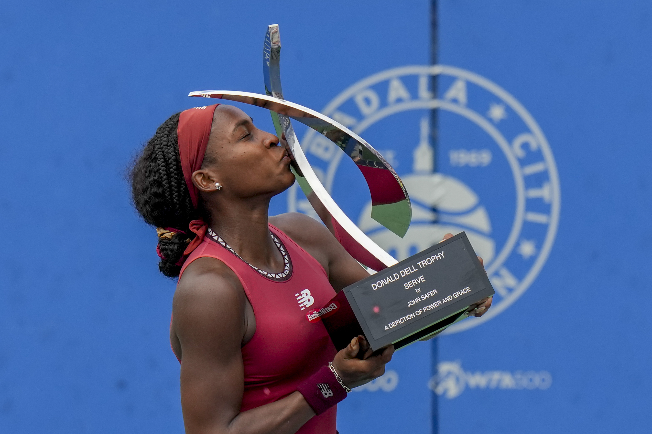 Coco Gauff, of the United States, kisses the trophy after defeating Maria Sakkari, of Germany, in the women's singles final of the DC Open tennis tournament Sunday, Aug. 6, 2023, in Washington. 