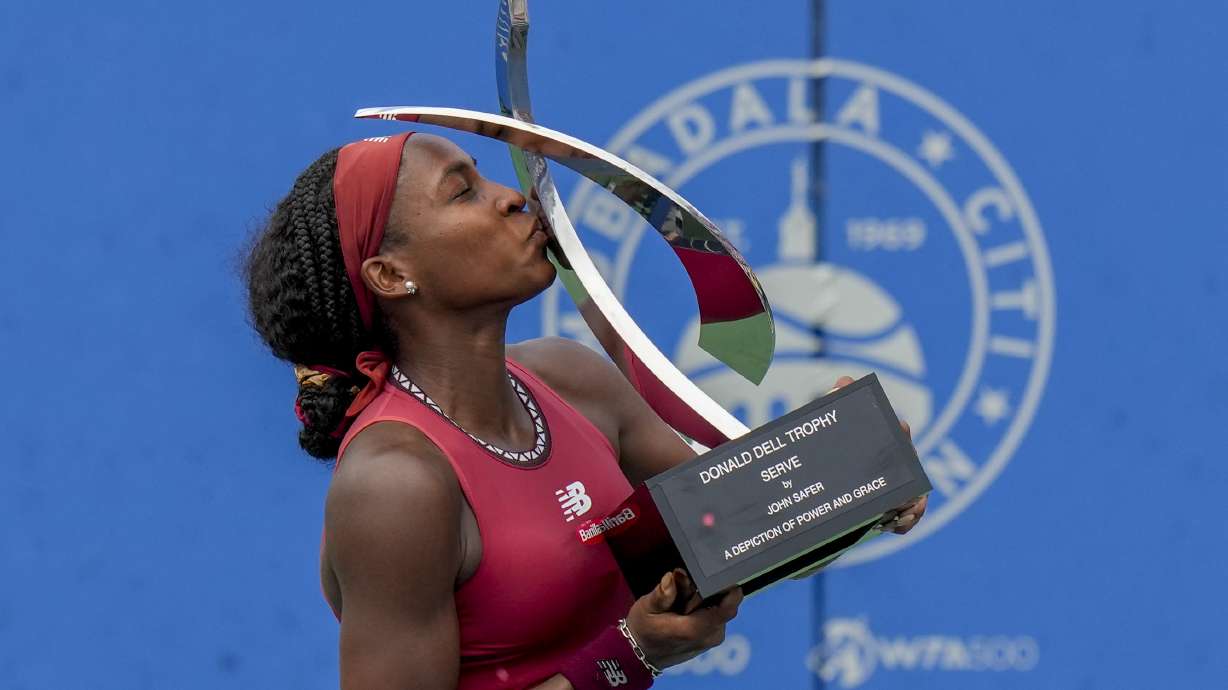 Coco Gauff, of the United States, kisses the trophy after defeating Maria Sakkari, of Germany, in the women's singles final of the DC Open tennis tournament Sunday, Aug. 6, 2023, in Washington.