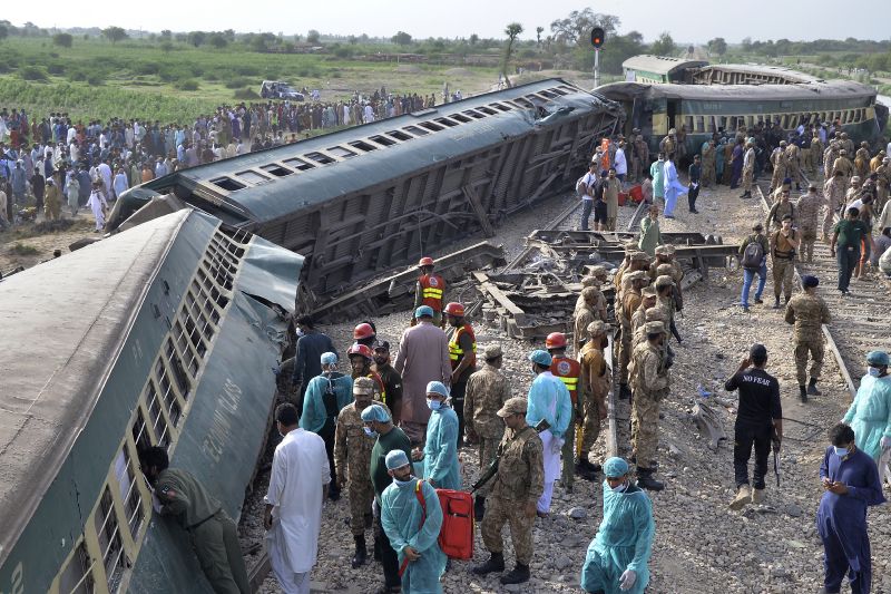 Rescue workers and army troops take in a rescue operation at the site of train derailed outskirts of Sarhari railway station Nawabshah, Pakistan, Sunday. Railway officials say some passengers were killed and dozens more injured when a train derailed near the town of Nawabshah in southern Sindh province.