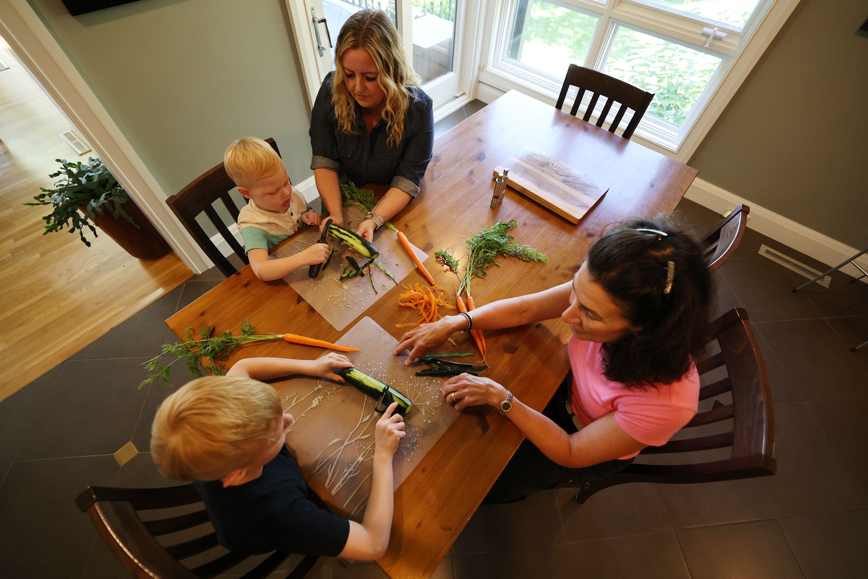 Dr. Bonnie Feola works with Michelle and her sons Ellis and Anderson at her home in Salt Lake City on July 26. Feola works with kids and parents on learning about eating healthy and how to prepare food.