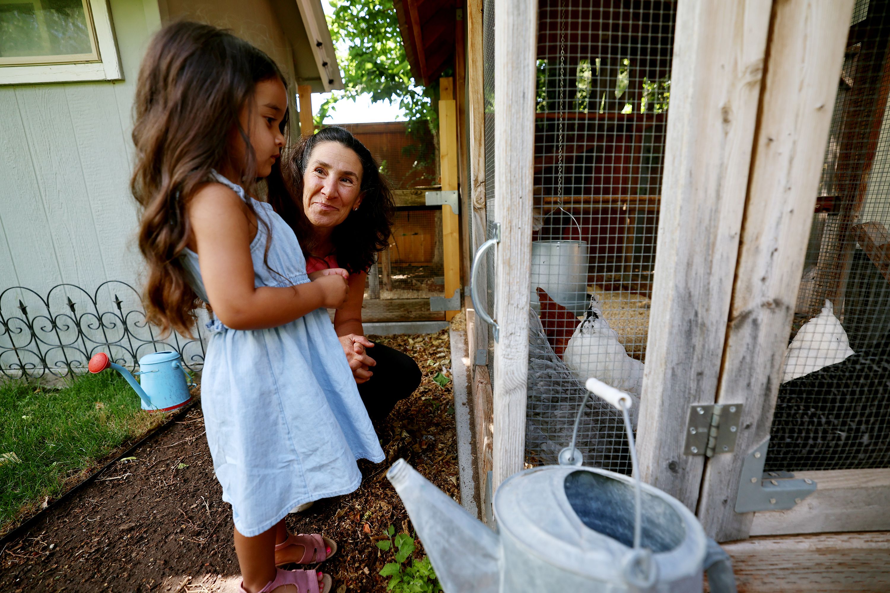 Dr. Bonnie Feola talks with Mila Gill about her chickens as Mila and her family visit Feola’s Salt Lake City home on July 26. Feola works with kids and parents on learning about eating healthy and how to prepare food.