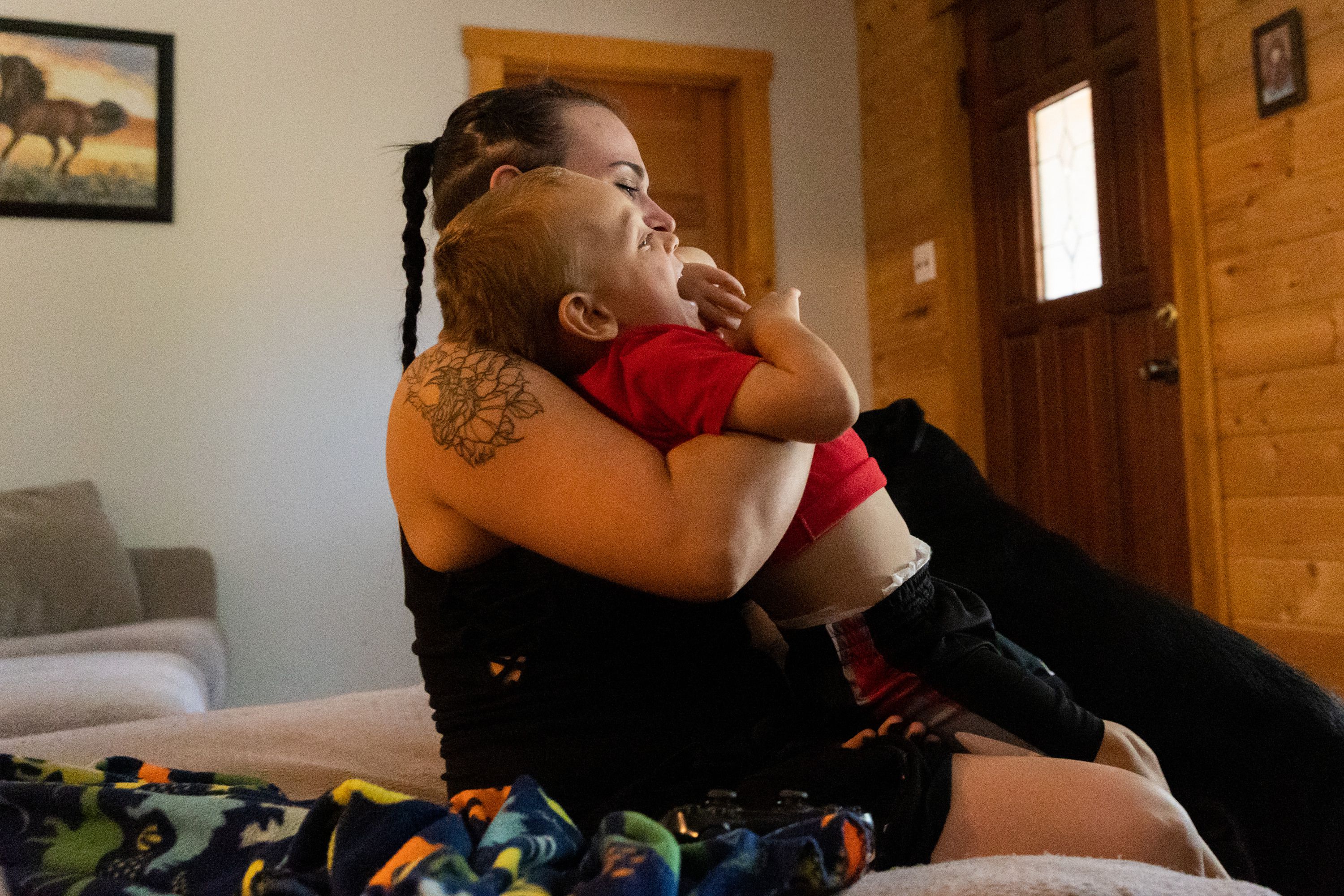 Tristen Parson plays with her son Enzo, 2, at her home in Ogden on Sunday.