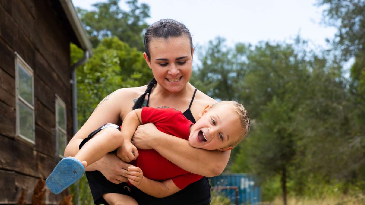 Tristen Parson plays with her son Enzo, 2, at her home in Ogden on Sunday. A new report details the many challenges single mothers face.