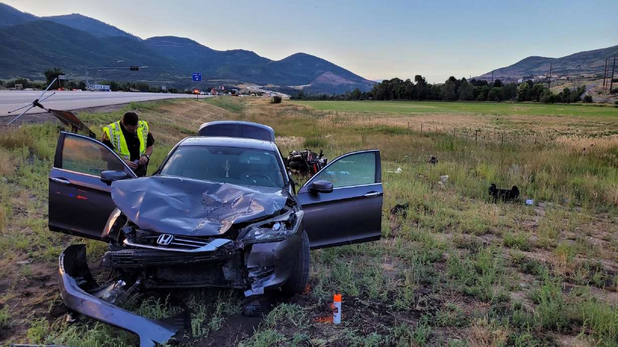 A woman died after the motorcycle she and her husband were riding in Heber City was hit by a car Thursday.