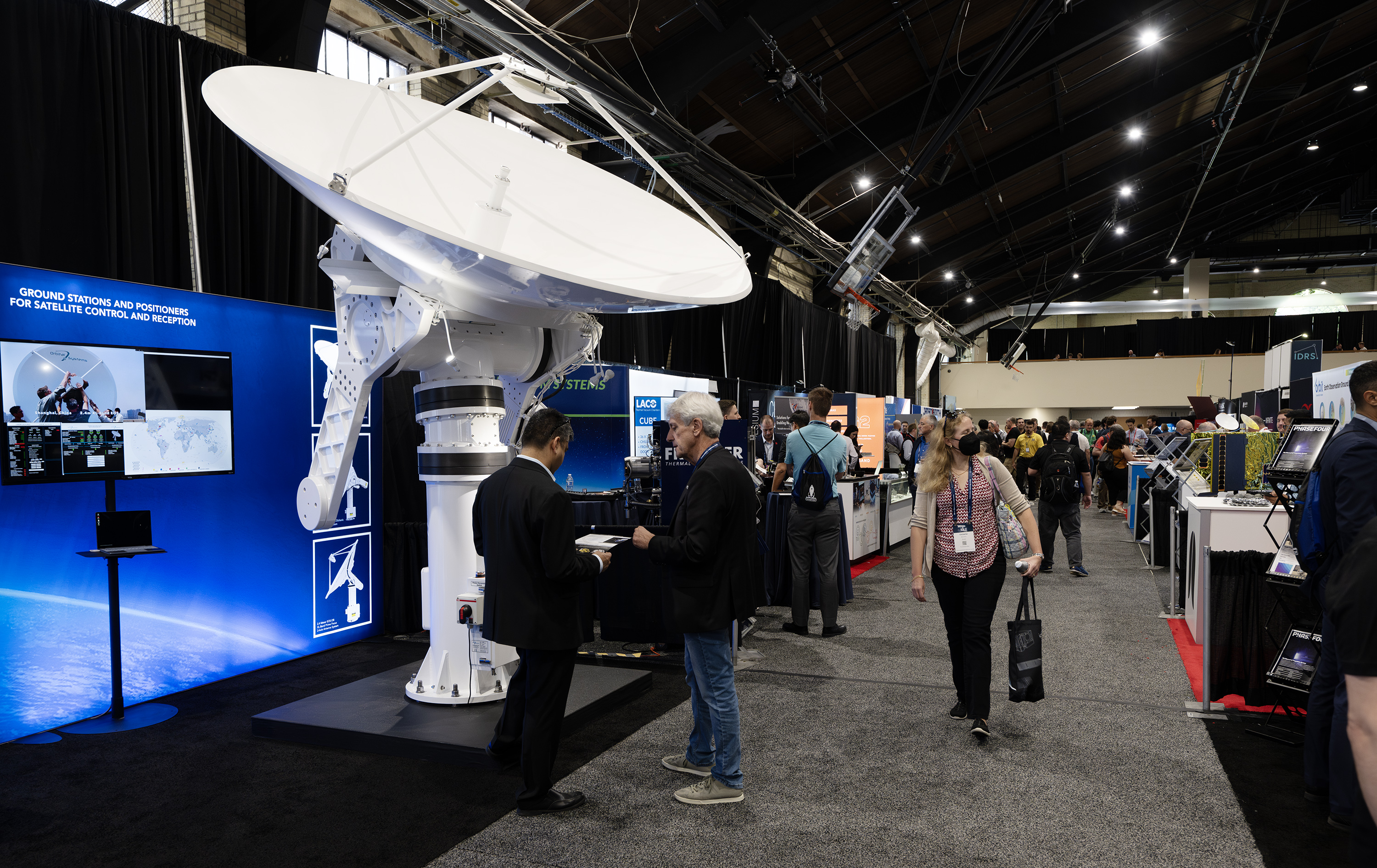Attendees of the Small Satellite Conference walk around visiting the many booths set up at Utah State University in Logan on Monday. Utah State University's 37th annual Small Satellite Conference started Saturday and runs through Thursday.