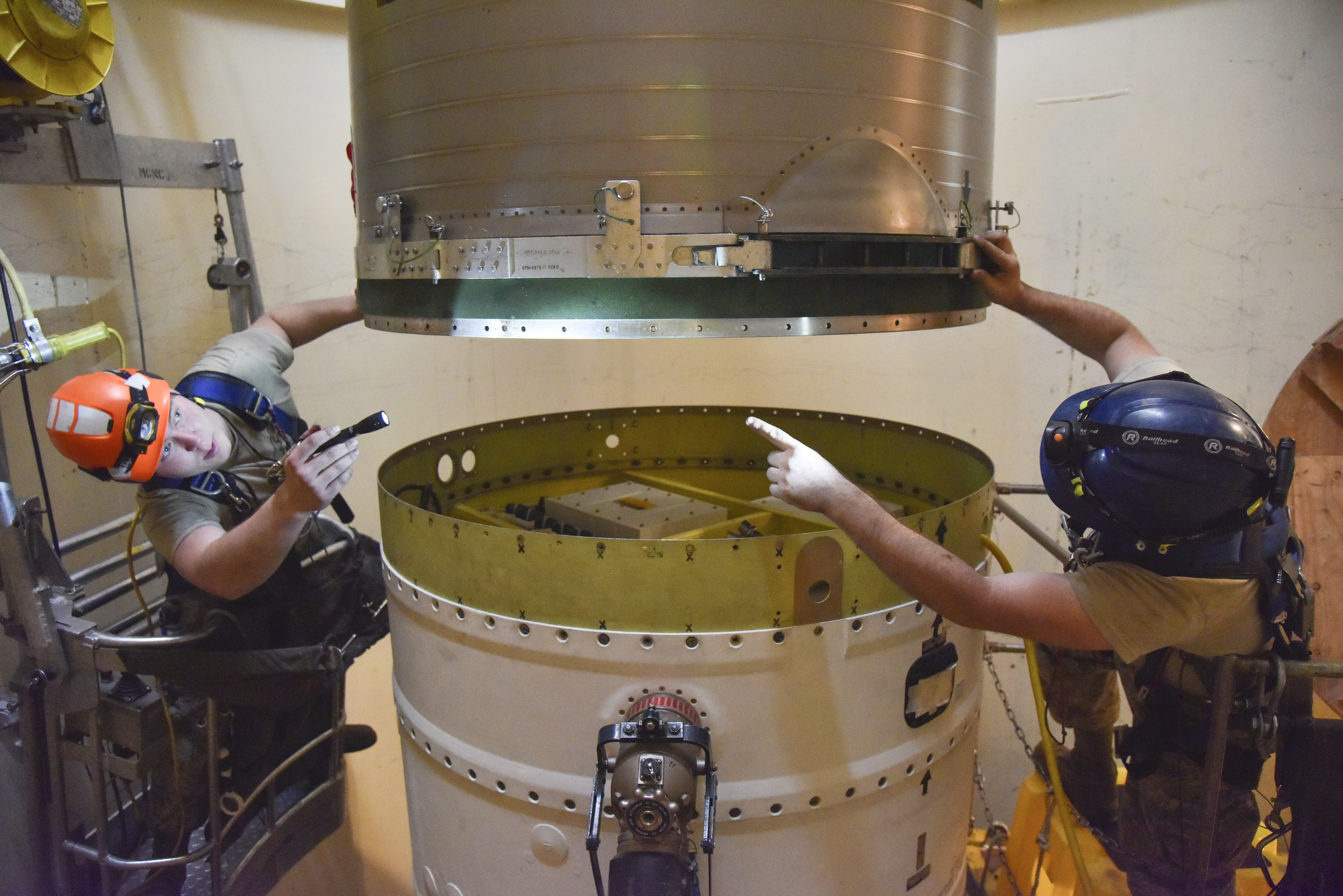 Airman 1st Class Jackson Ligon, left, and Senior Airman Jonathan Marinaccio, 341st Missile Maintenance Squadron technicians connect a re-entry system to a spacer on an intercontinental ballistic missile Sept. 22, 2020, near Malmstrom Air Force Base in Great Falls, Mont. The Air Force has temporarily closed two nuclear launch facilities after finding unsafe levels of a likely carcinogen in air samples at a Montana missile base.