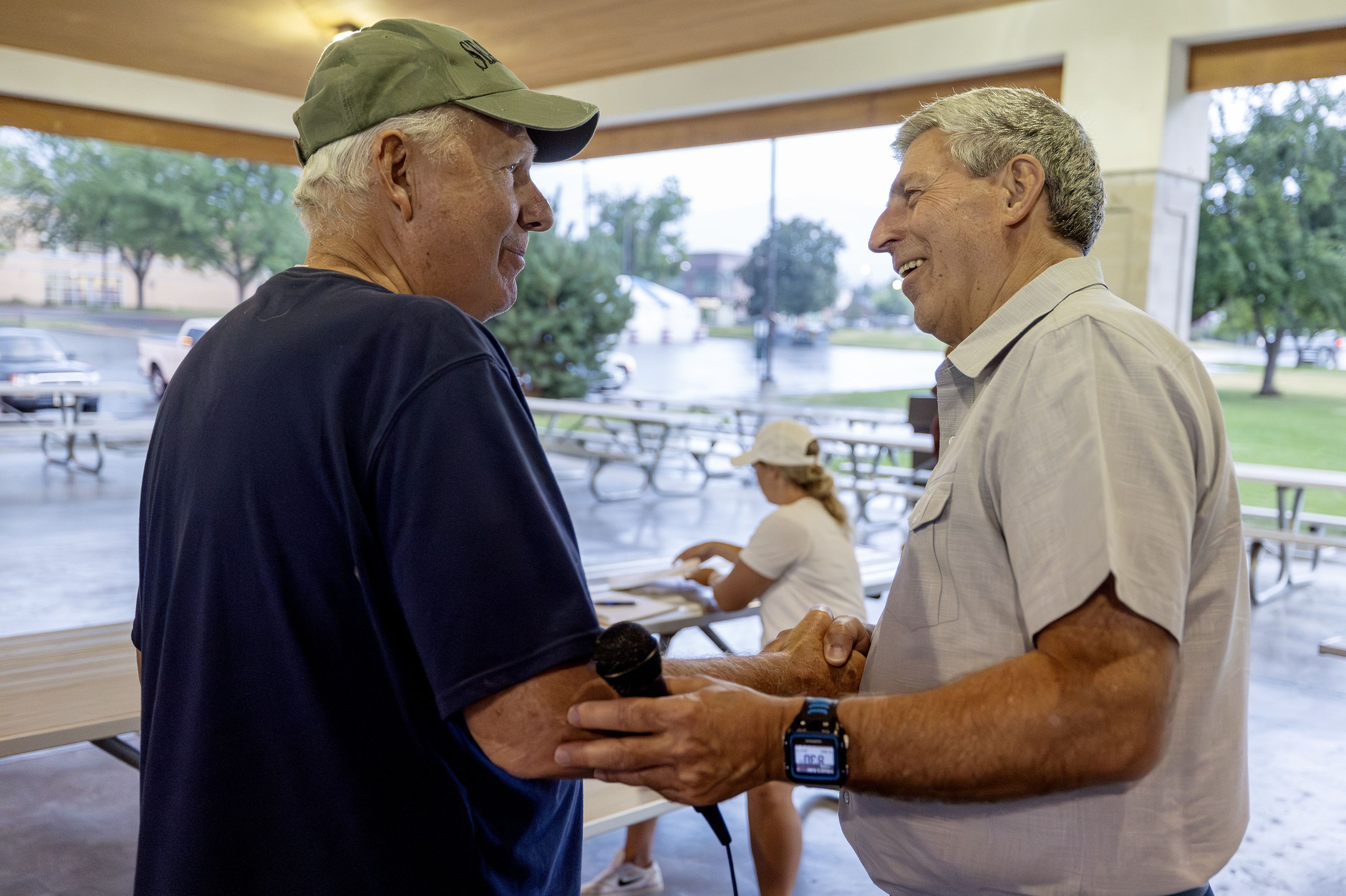 Robert Craig shakes hands with Utah 2nd Congressional District candidate Bruce Hough at a gathering at Bountiful Park on July 19.
