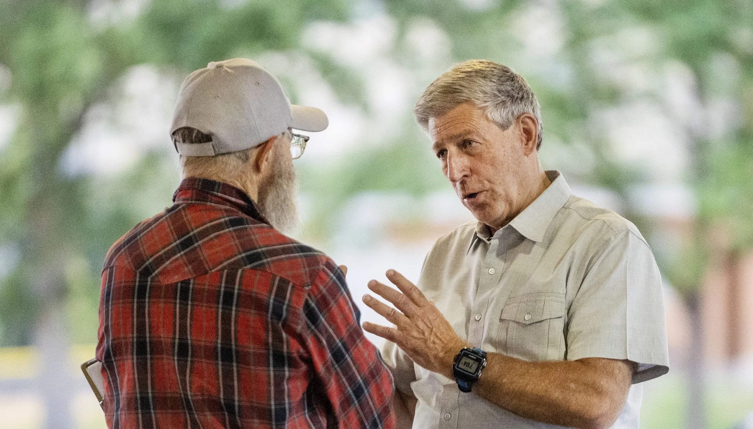 Utah 2nd Congressional District candidate Bruce Hough talks with Ron Mortensen at a gathering at Bountiful Park on July 19.