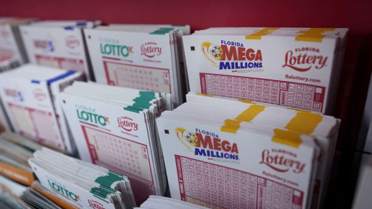Lottery forms are shown, Monday at the Presidente Supermarket in the Little Havana neighborhood of Miami. Mega Millions jackpot has grown to $1.55 billion, making it the third-largest ever ahead of Tuesday night's drawing.
