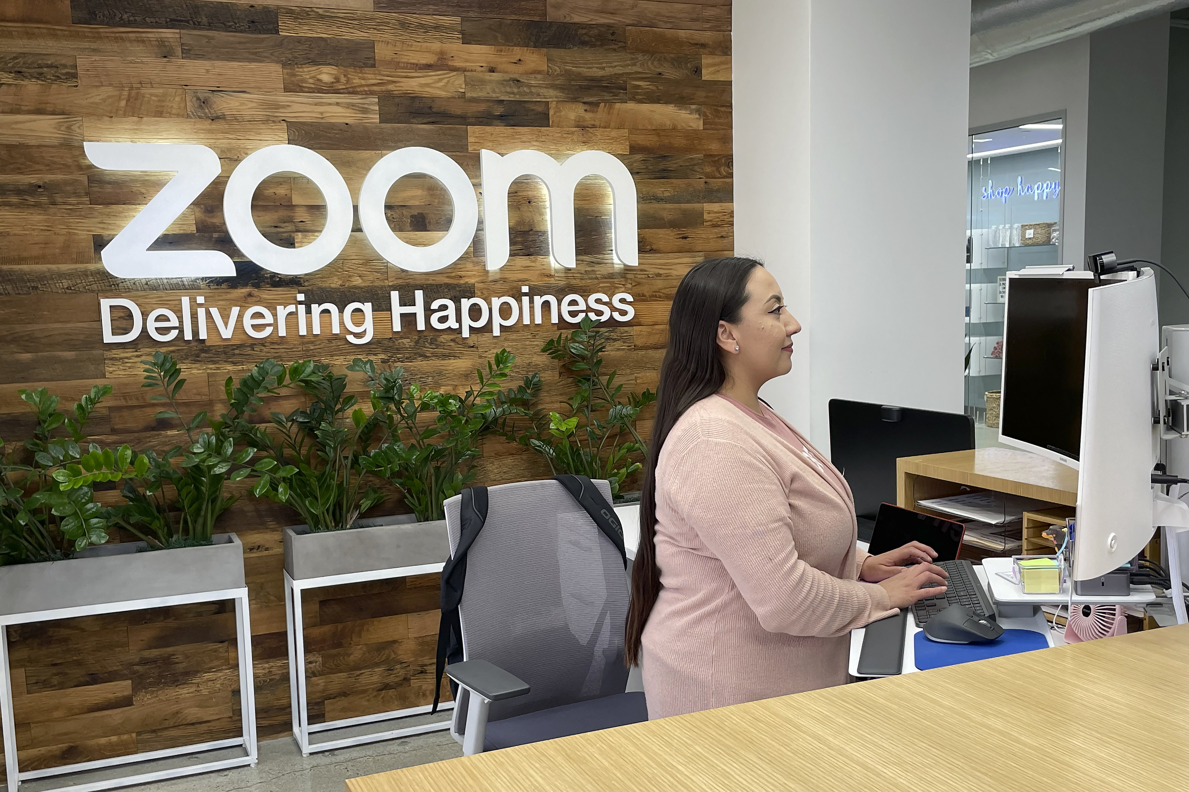 A woman works at Zoom headquarters on Feb. 3 in San Jose, Calif. Zoom is asking employees who live within a 50-mile radius of its offices to work onsite two days a week. 