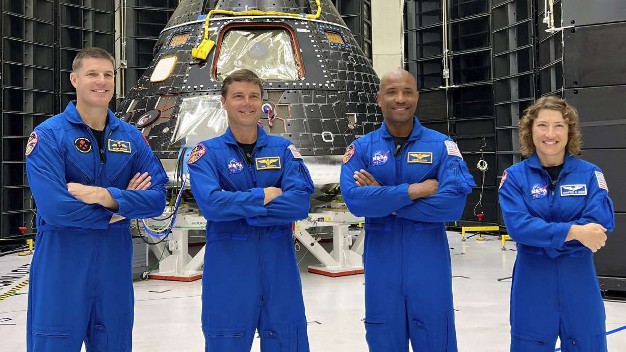 This photo posted on X, formerly known as Twitter, on Aug. 8 shows astronauts, from left, Jeremy Hansen, Reid Wiseman, Victor Glover and Christina Koch at Florida's Kennedy Space Center. The four, who will fly to the moon in 2024, have gotten their first up-close look at their spacecraft, the Orion capsule, background, during a visit on late Monday and Tuesday.
