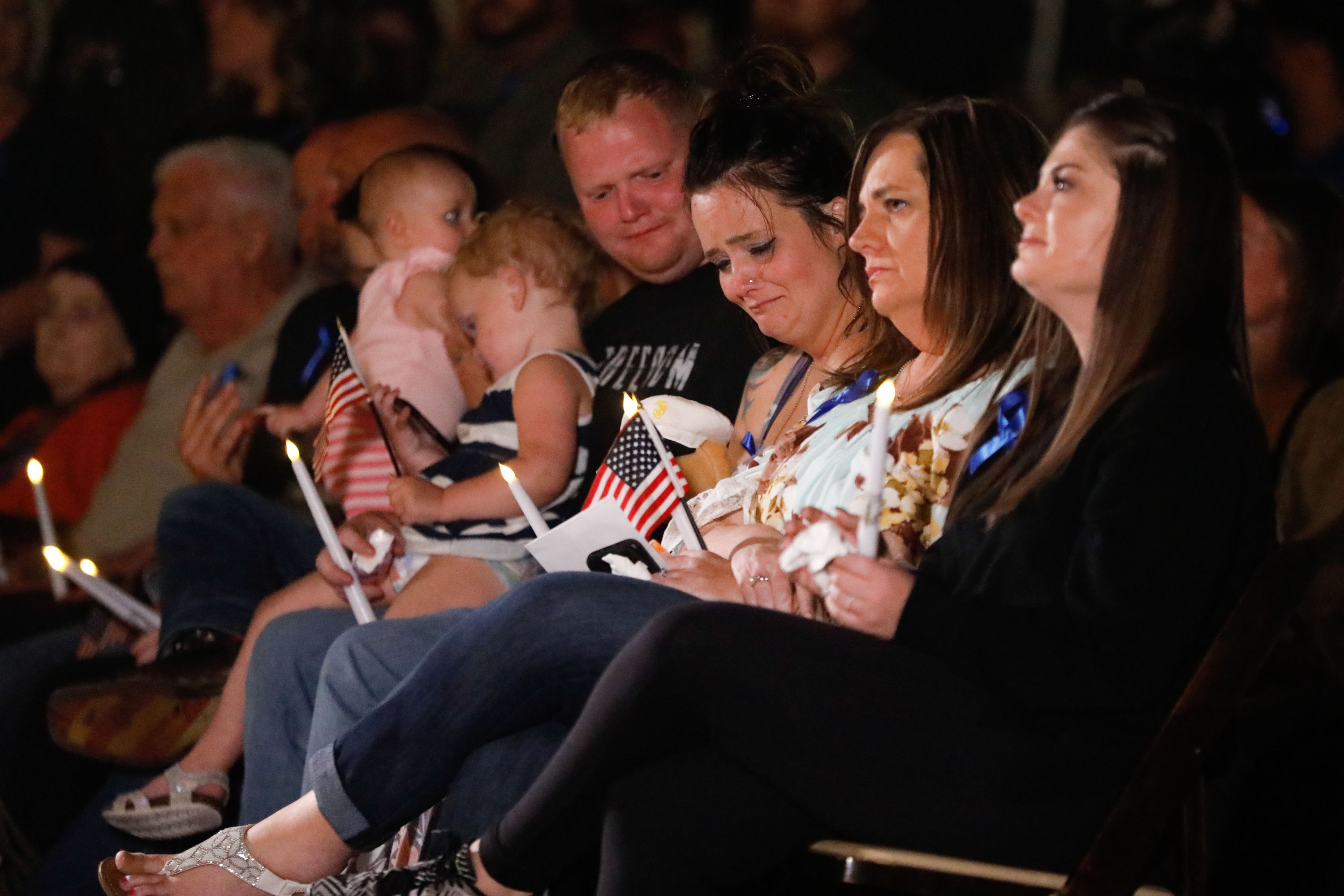 Family members attend a vigil to honor the life and service of Marine Staff Sgt. Taylor Hoover at the Capitol in Salt Lake City on Aug. 29, 2021. Hoover was one of the 13 U.S. service members killed by the terrorist attack at Hamid Karzai International Airport in Kabul, Afghanistan.