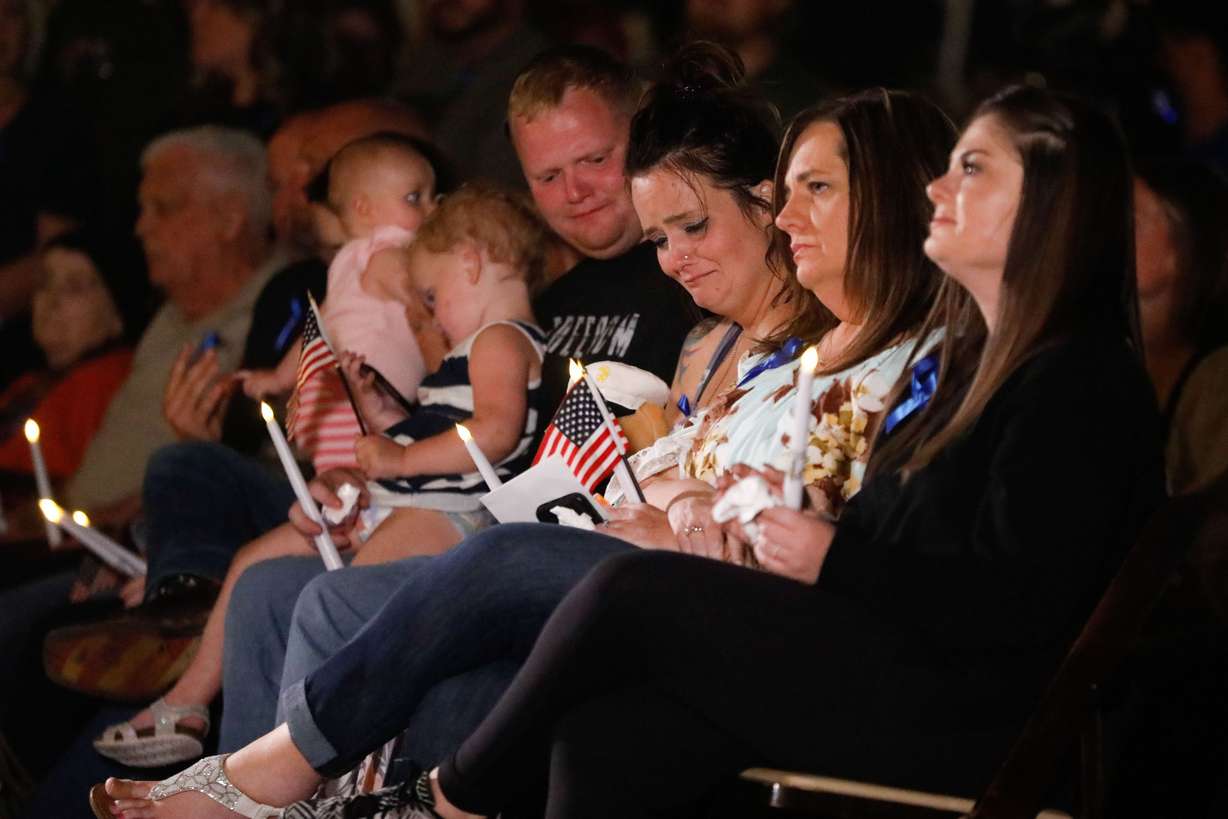 Family members attend a vigil to honor the life and service of Marine Staff Sgt. Taylor Hoover at the Capitol in Salt Lake City on Aug. 29, 2021. Hoover was one of the 13 U.S. service members killed by the terrorist attack at Hamid Karzai International Airport in Kabul, Afghanistan.