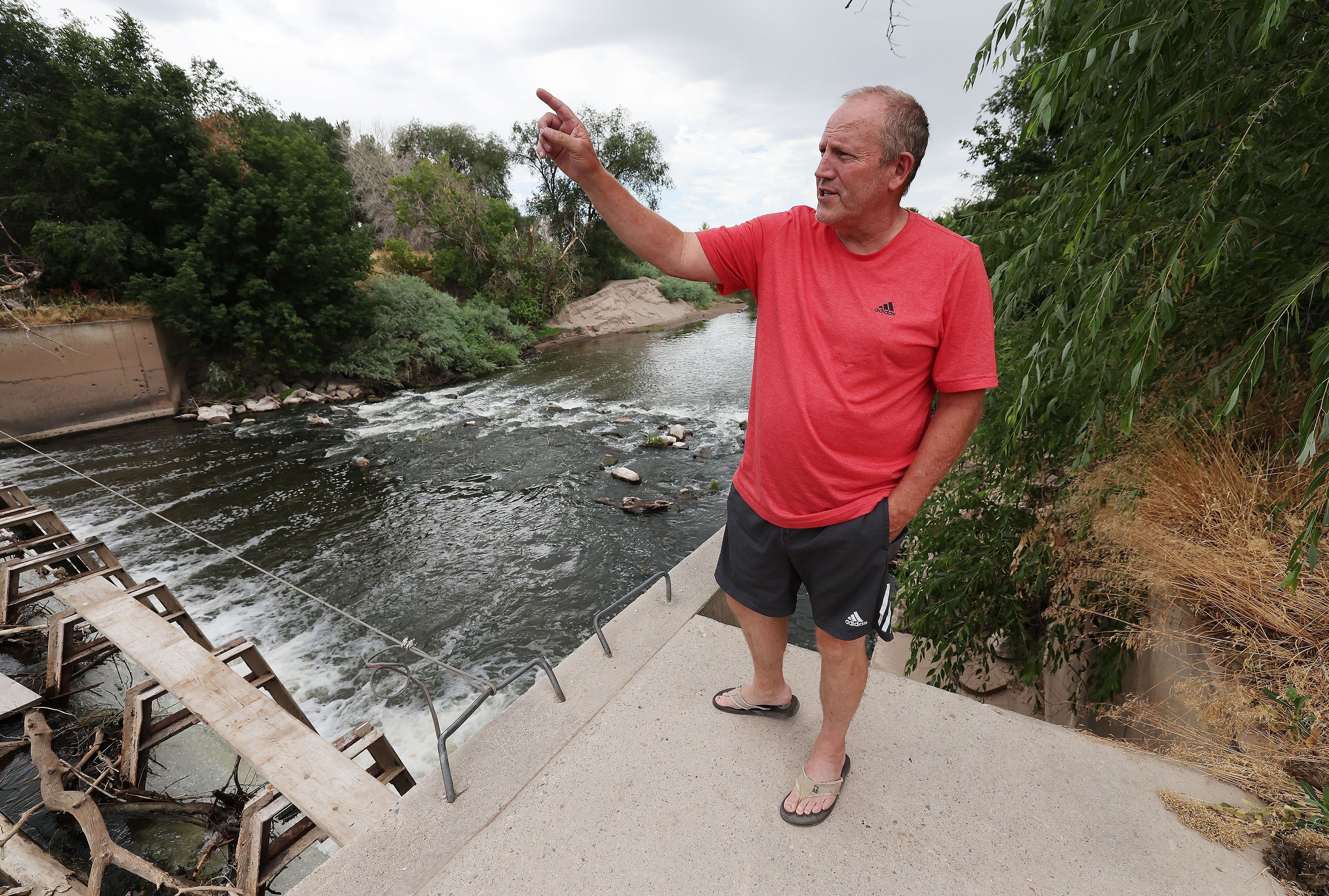 Brad Blanch looks over a dam on the Weber River in Weber County on July 26. Blanch is a West Weber resident who wants to lease several hundred acre-feet of water to benefit the Great Salt Lake.