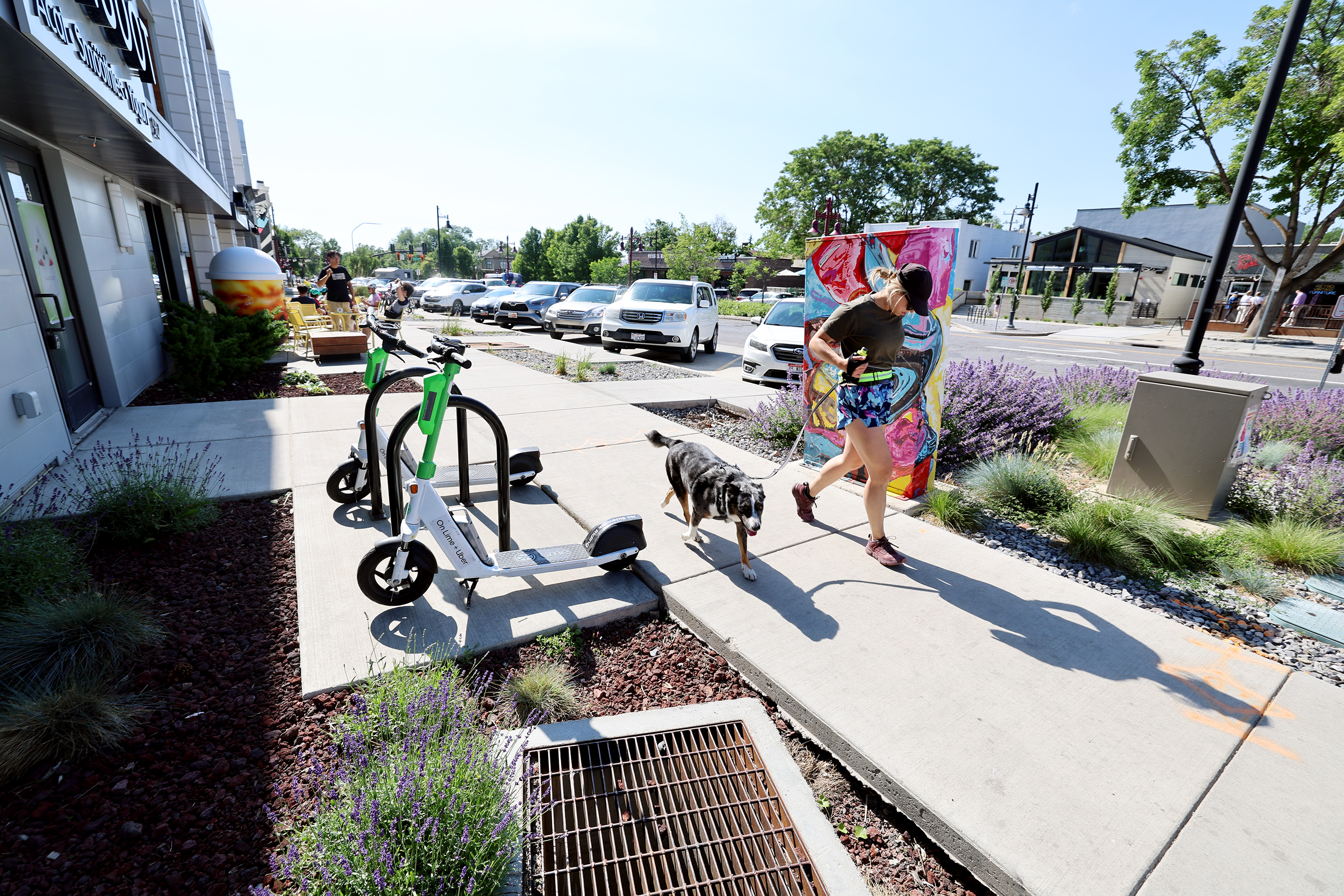 A woman and a dog run near 900 South and 900 East in Salt Lake City on June 20. The Salt Lake City Council is close to figuring out how it will spend nearly $40 million in capital improvement projects during the 2024 fiscal year.