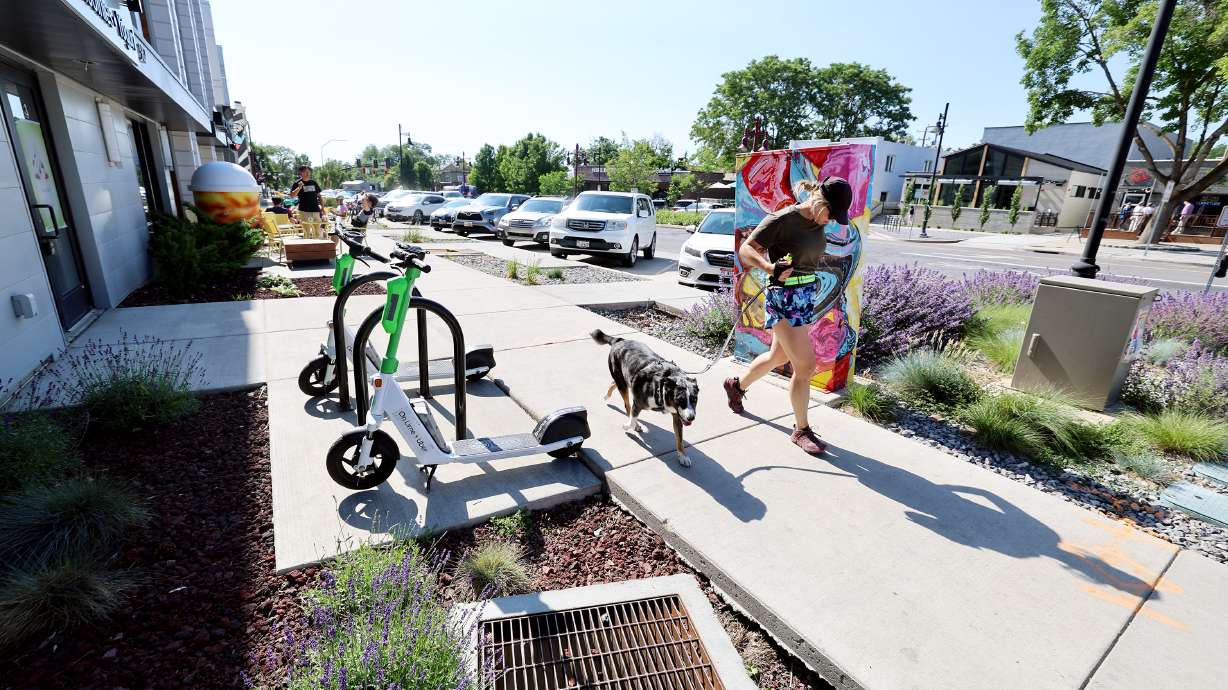 A woman and a dog run near 900 South and 900 East in Salt Lake City on June 20. The Salt Lake City Council is close to figuring out how it will spend nearly $40 million in capital improvement projects during the 2024 fiscal year.
