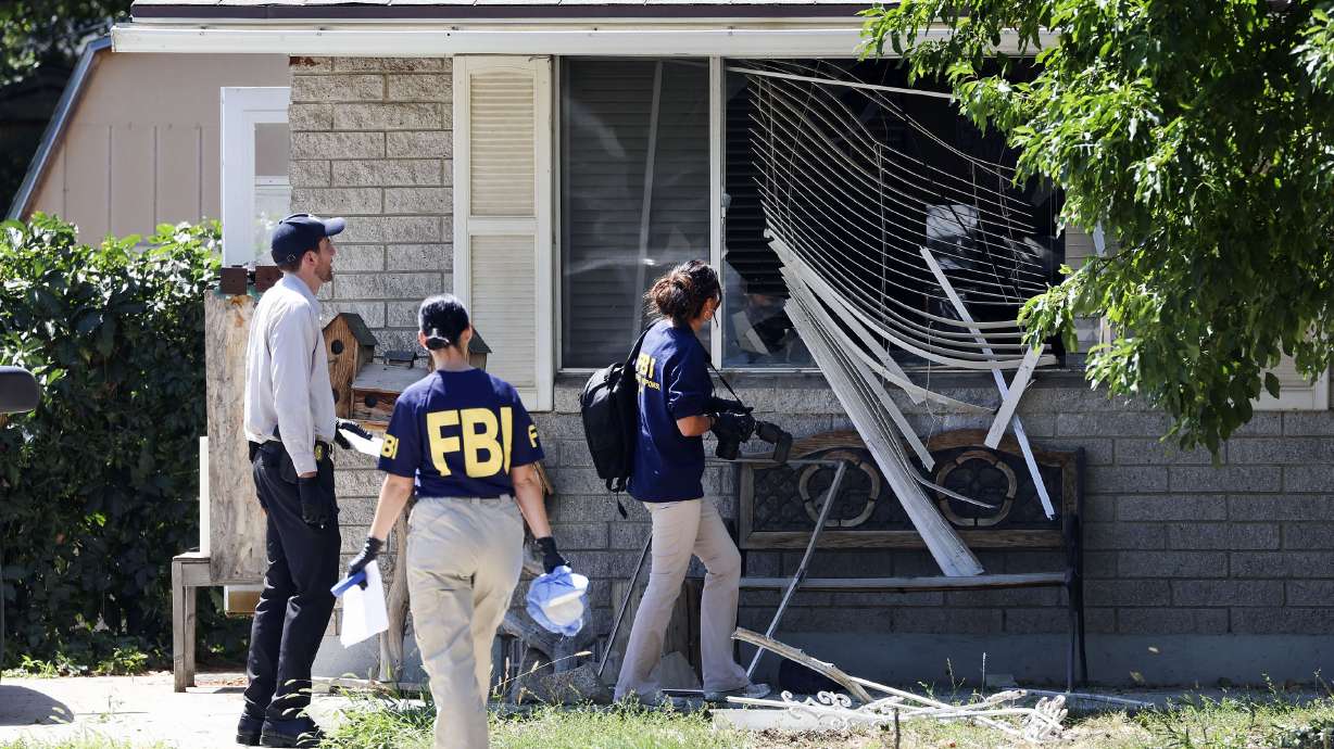 Law enforcement agents investigate at the home of Craig Deeleuw Robertson who was shot and killed by FBI agents in Provo on Wednesday. The FBI said Monday that he pointed a gun at agents before they shot and killed him.
