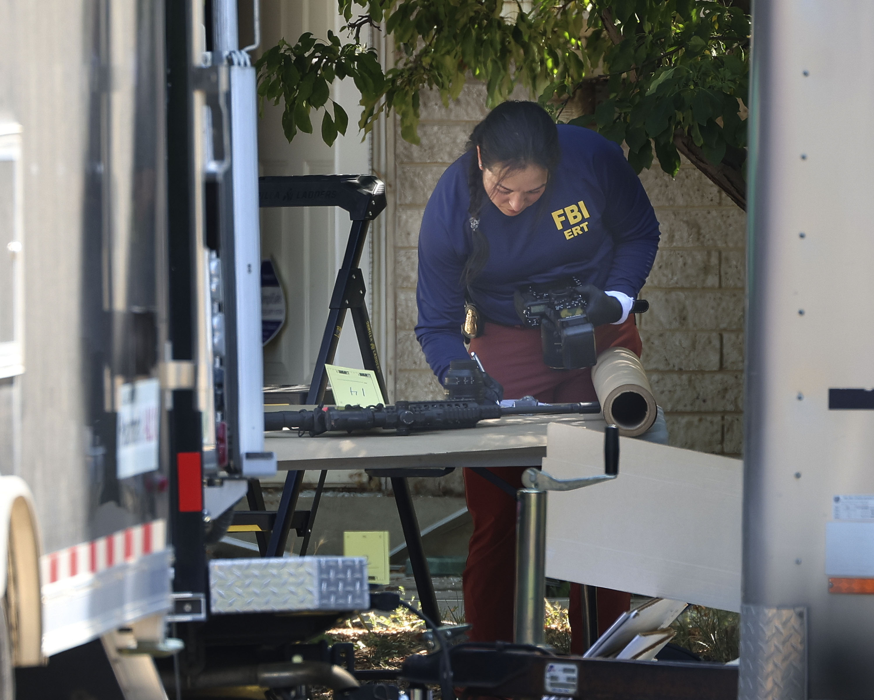 Investigators at the home of Craig Robertson, who was shot and killed by FBI agents in Provo on Wednesday. His family is now speaking out.