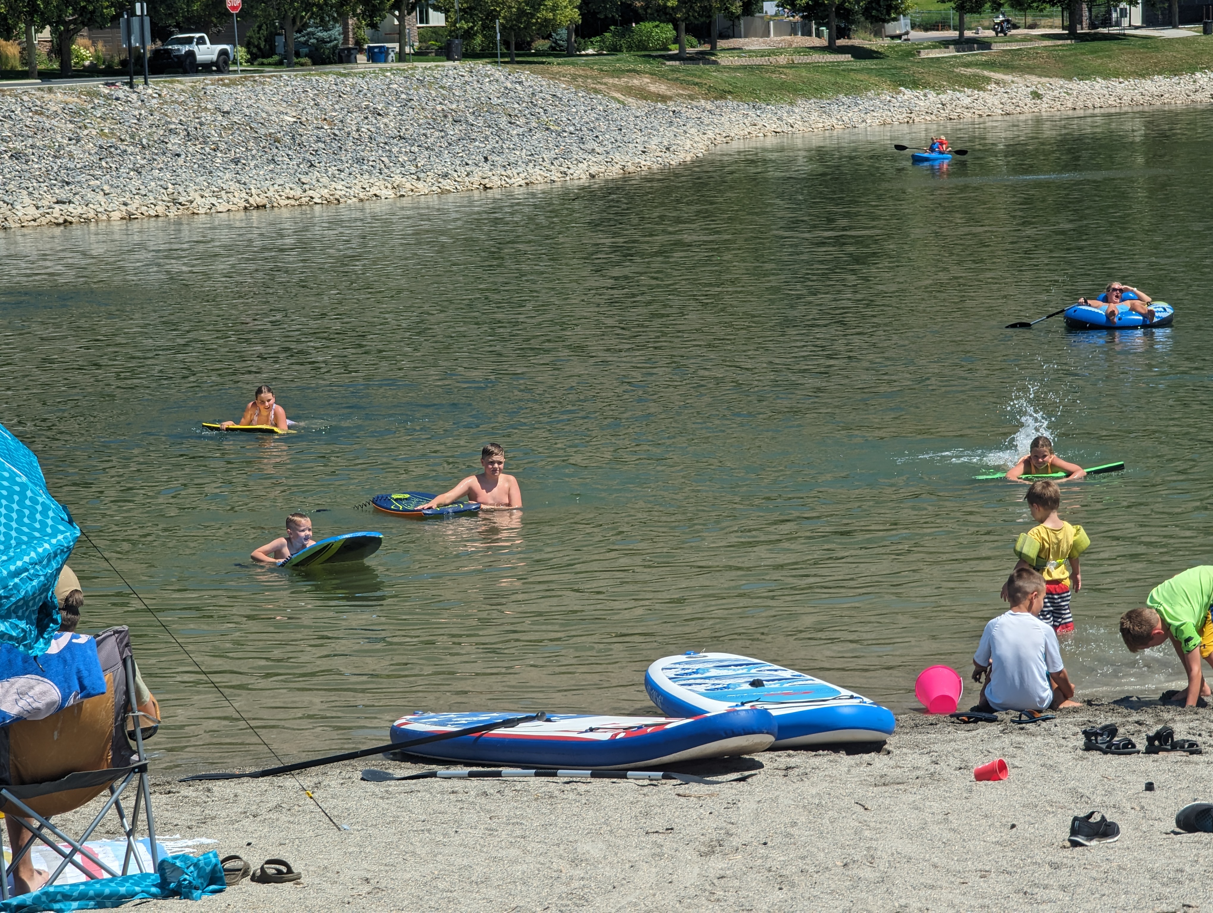 Kids swim and splash at Manila Creek Pond in Pleasant Grove, with many families unaware that a health advisory has been issued for the pond. Families say poor signage is not giving swimmers the warning they need to beware of possible E. coli in the water.